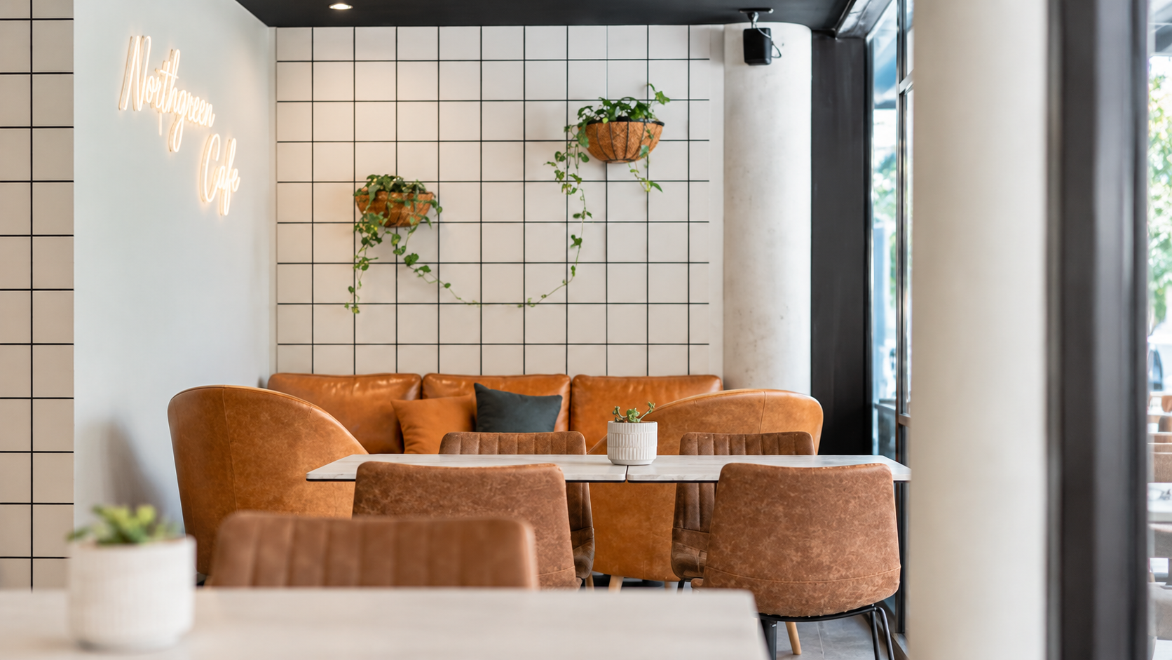 Modern Café Corner with Hanging Plants (1).png