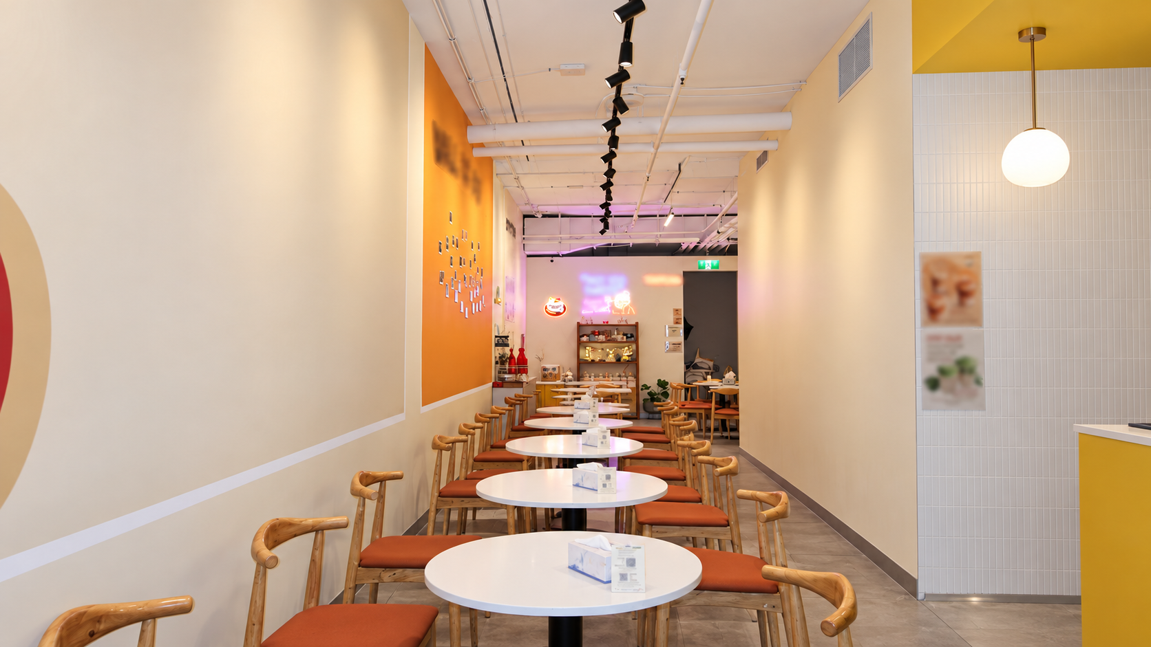 Premium Cafe Interior with Orange Accent Wall.png