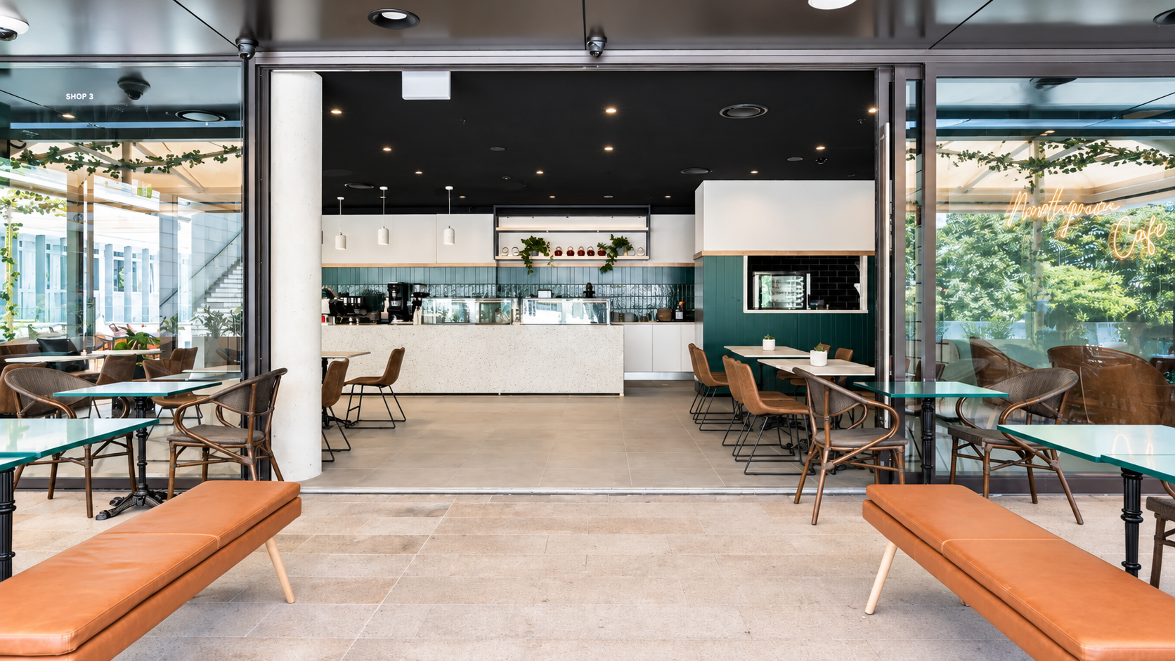 Modern Café Shopfront with Outdoor Seating.png