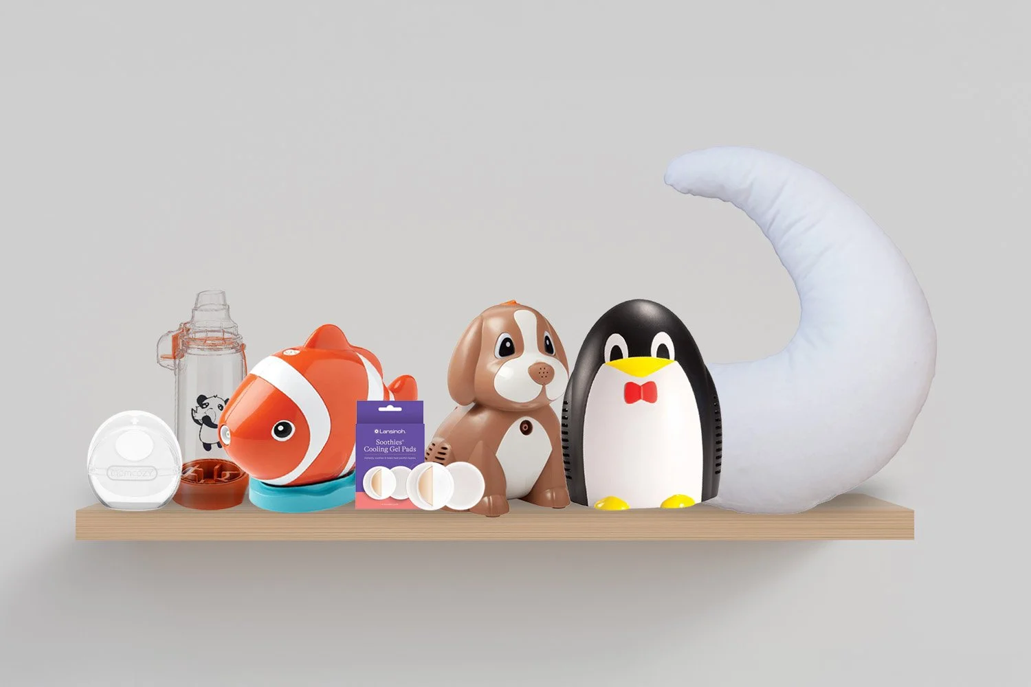 birchwood shelf on white wall showcasing pediatric medical items for sale including animal shaped nebulizers and breastfeeding pillow
