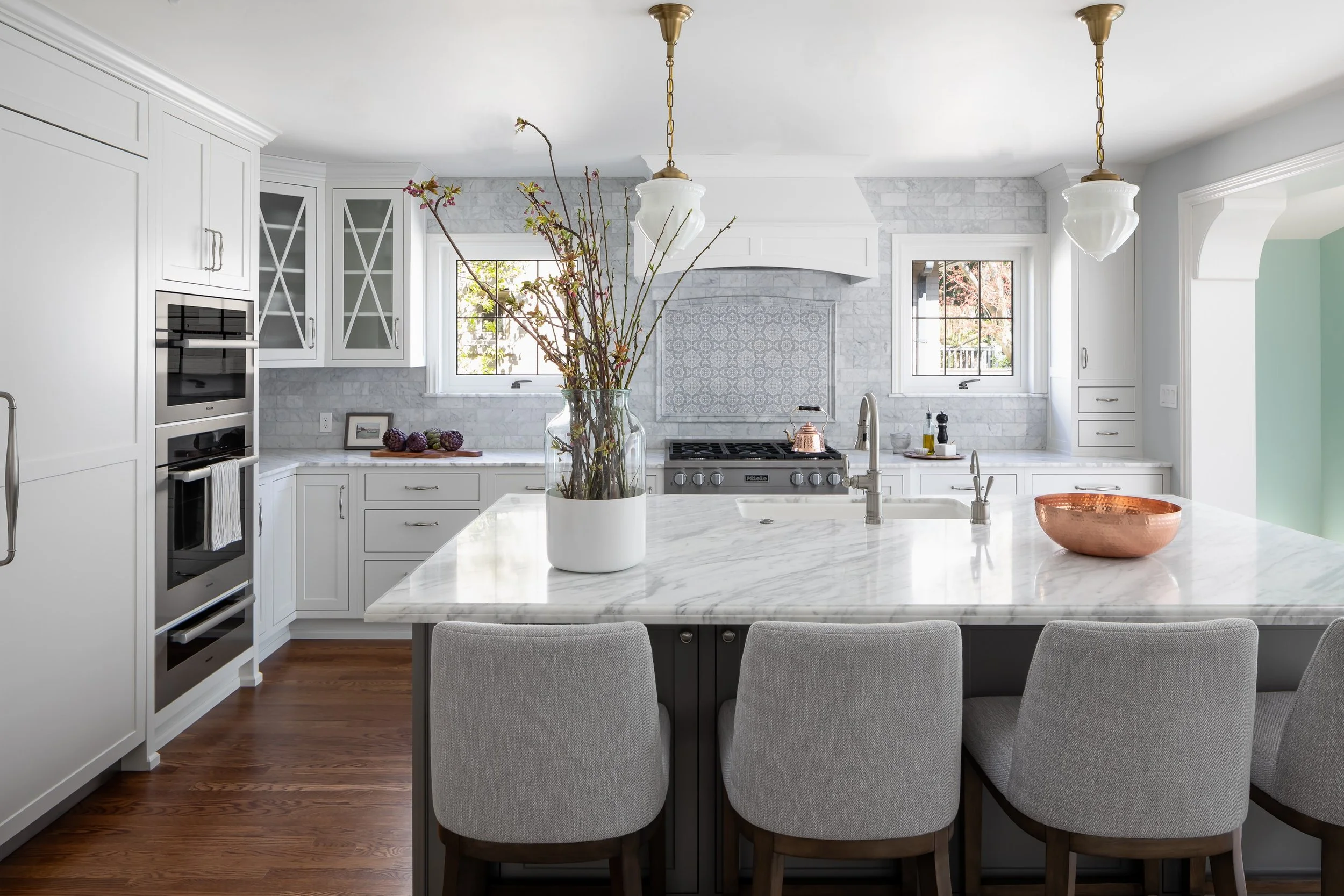 kirk riley design remodeled this Madison Park traditional kitchen with marble and white inset cabinets.