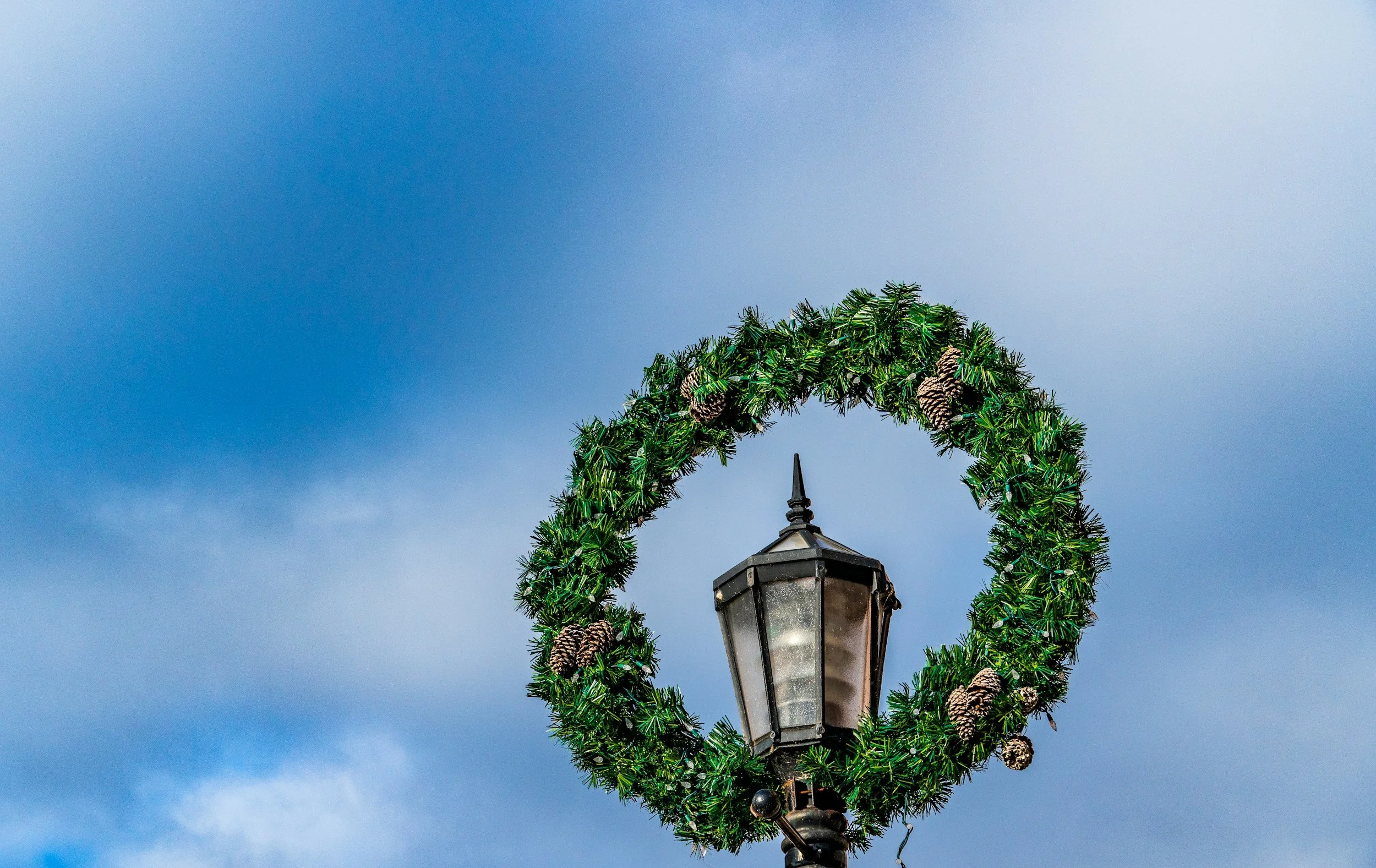 Pine wreath over a lantern for ASFSB's Holiday Auction