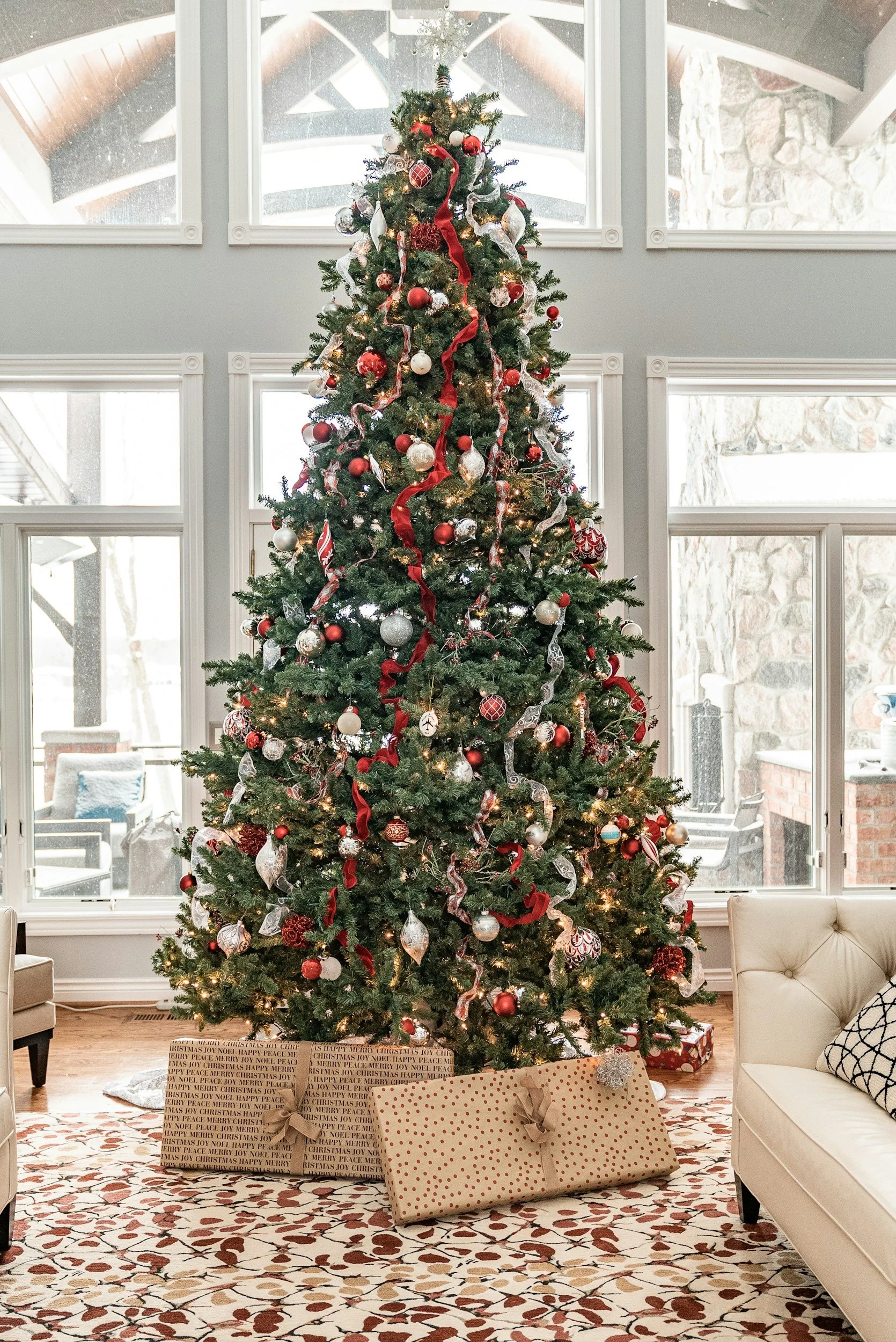 A decorated Christmas tree inside a windowed room