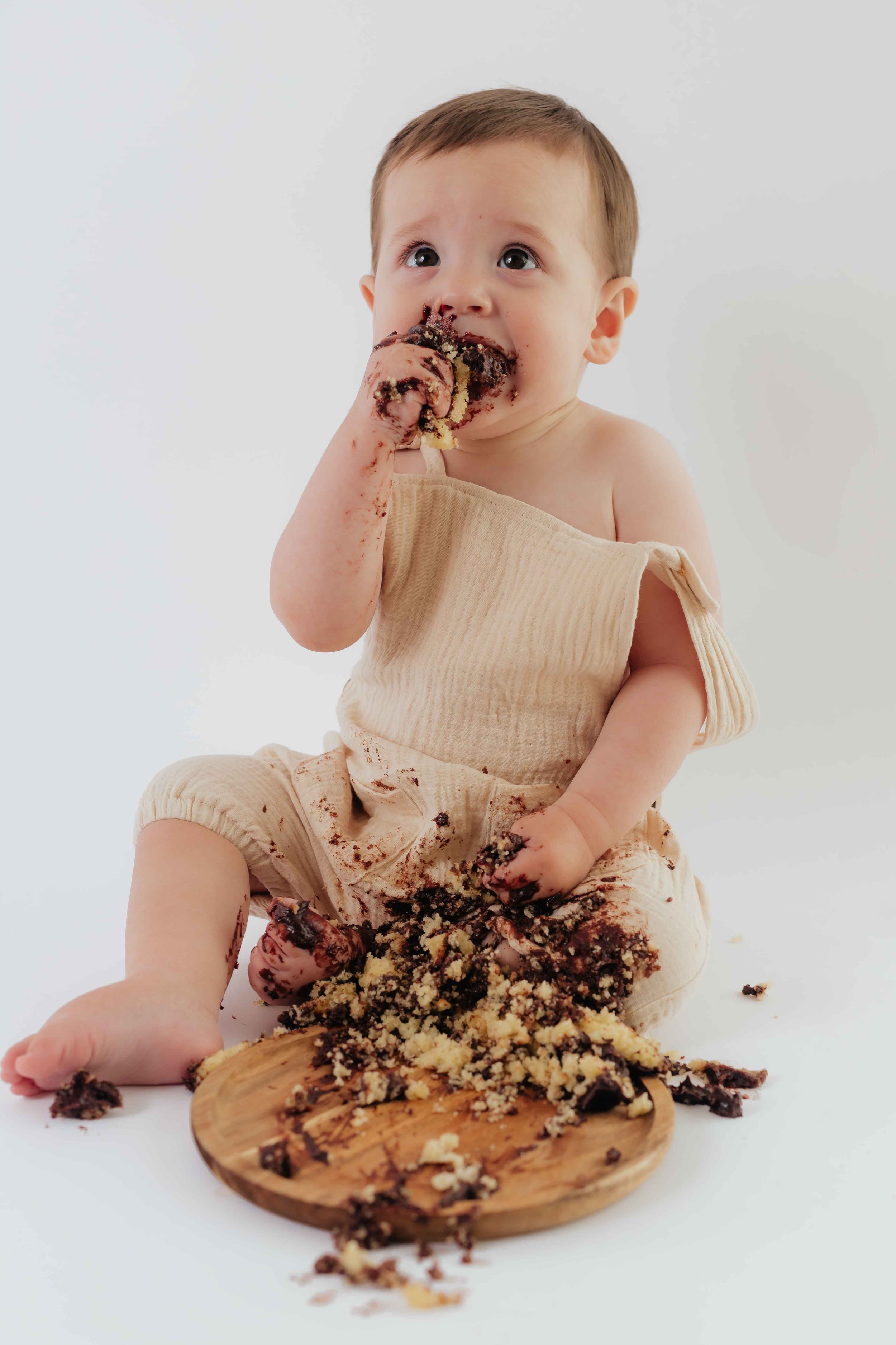the cutest bite of chocolate cake during cake smash