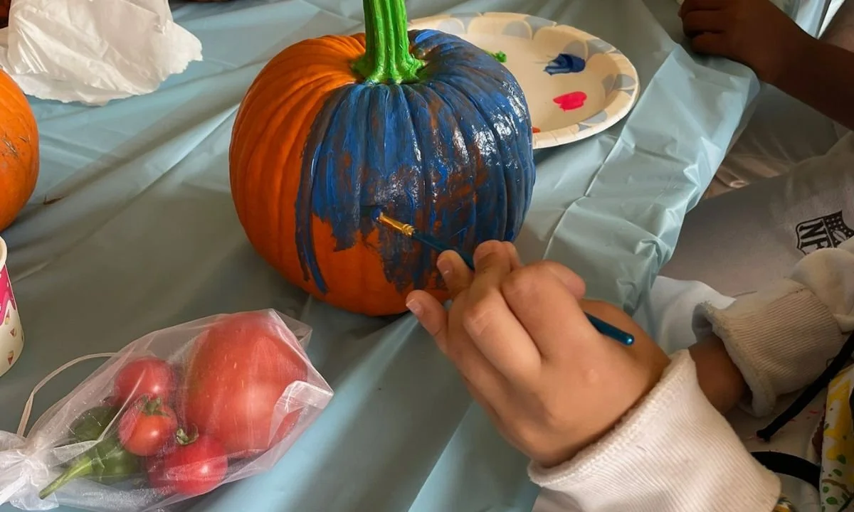 Child painting a pumpkin
