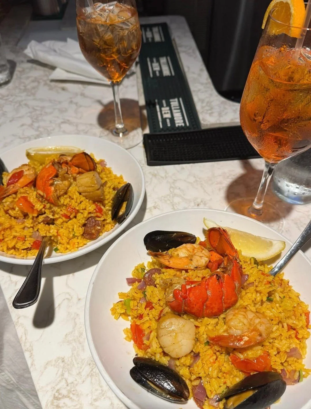 Seafood Paella 💫  lobster tail, shrimp, scallops, mussels, red onion, piquillo peppers, chorizo, saffron rice

📸  @danggooddishes