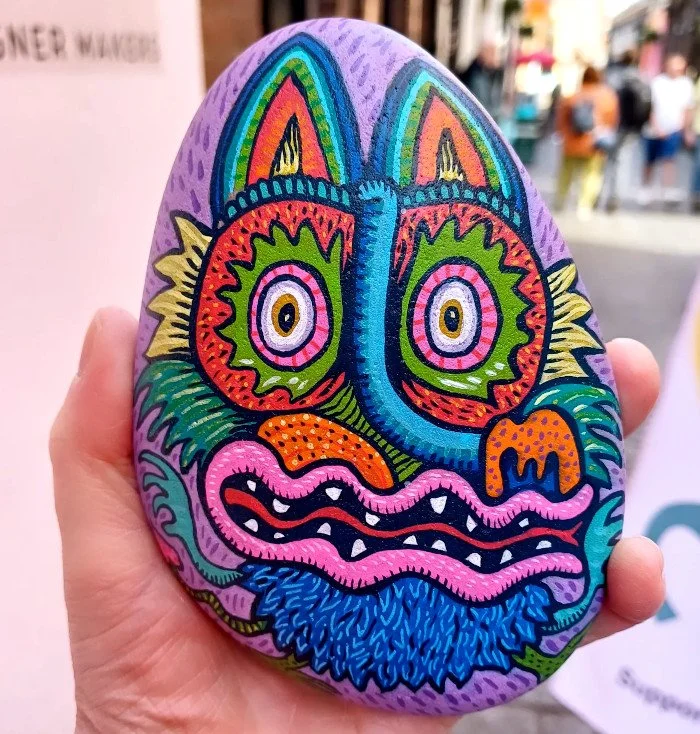 Handpainted freestyle characters on stones, inspired by local folklore and pop-culture