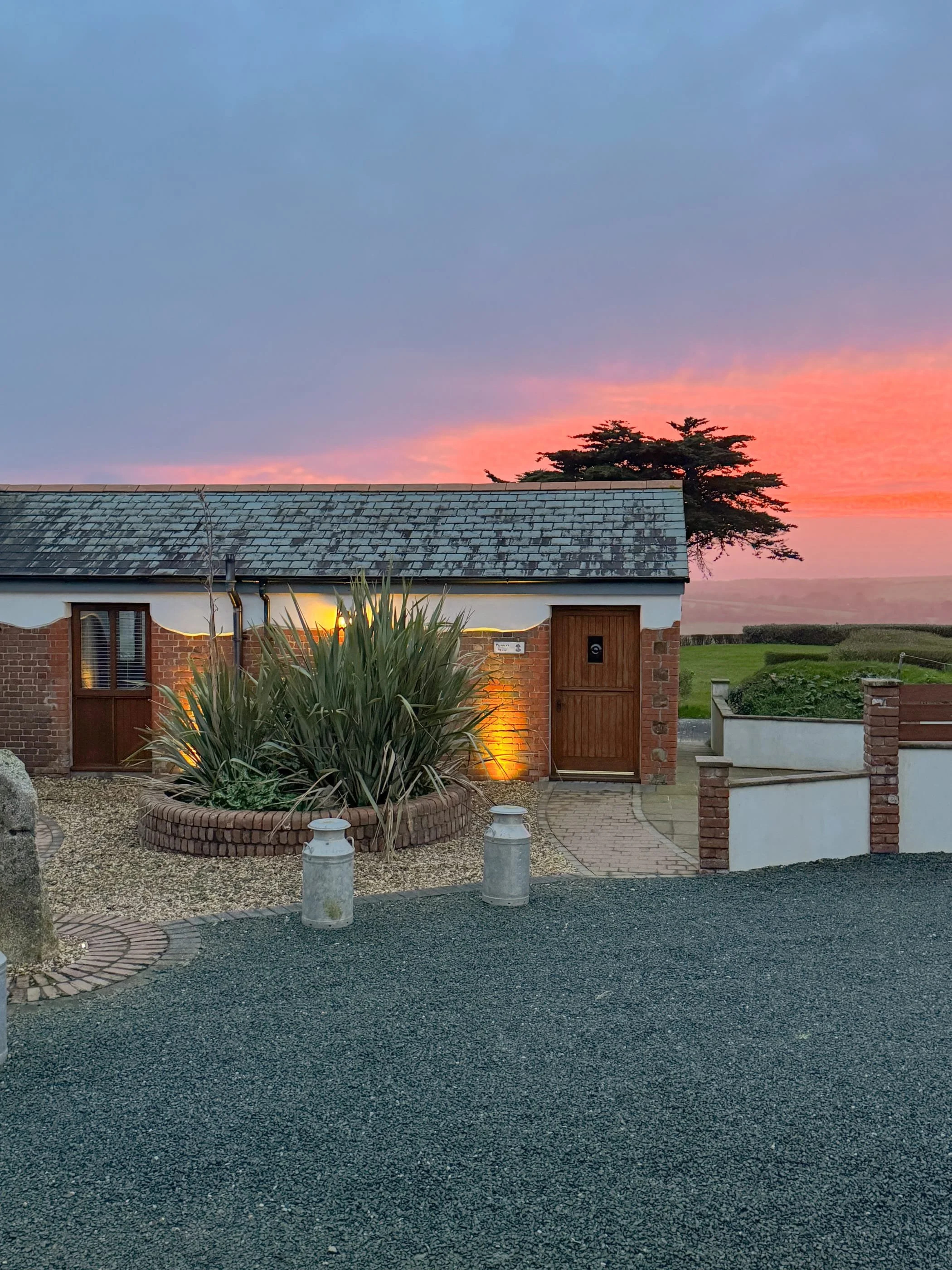 Wenna's Well at sunset over Widemouth Bay