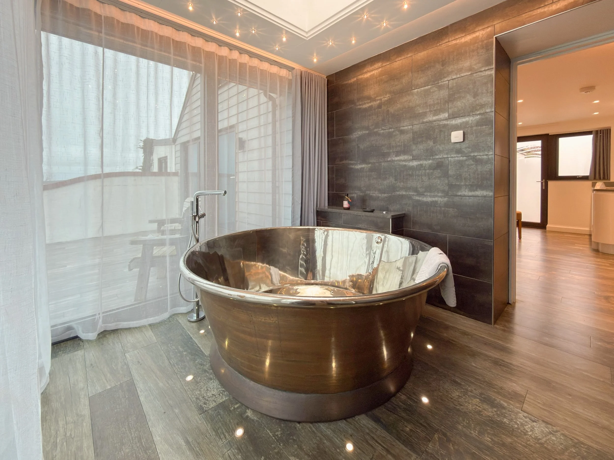 Air-spa bath with glistening nickel interior and patina copper finish