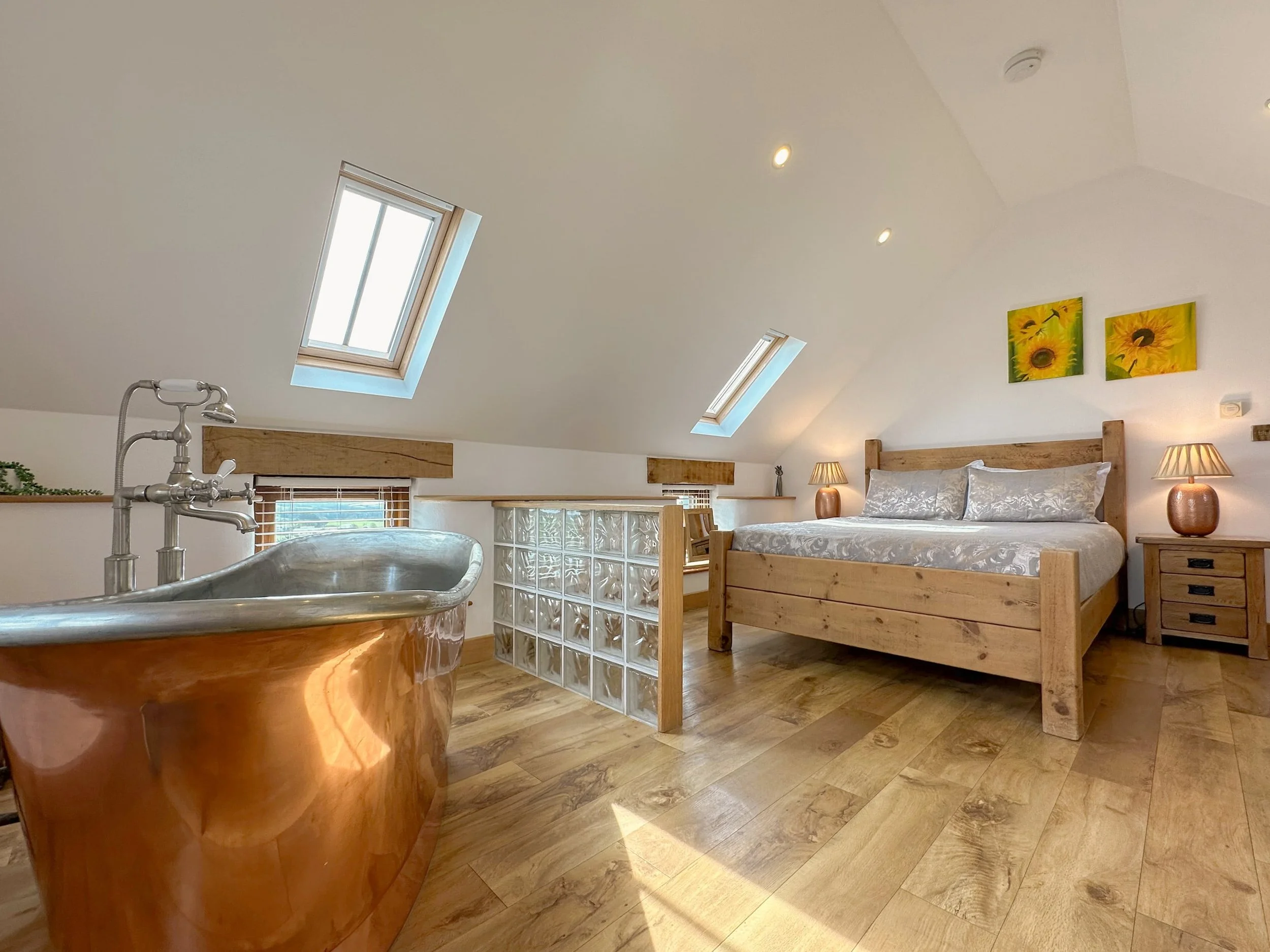 Loft plank bed and freestanding copper bath