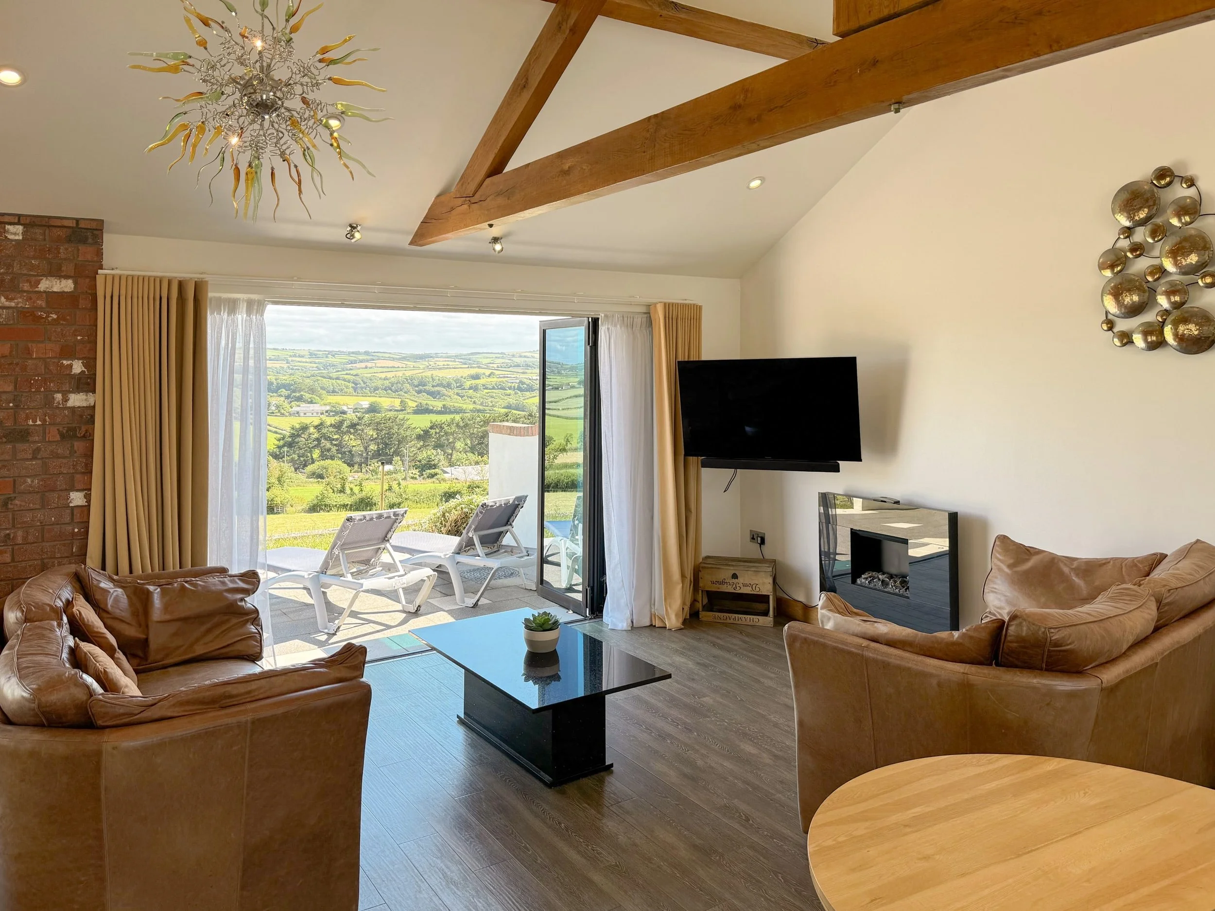 Open plan apartment with air-spa bath and bi-folding doors with countryside view