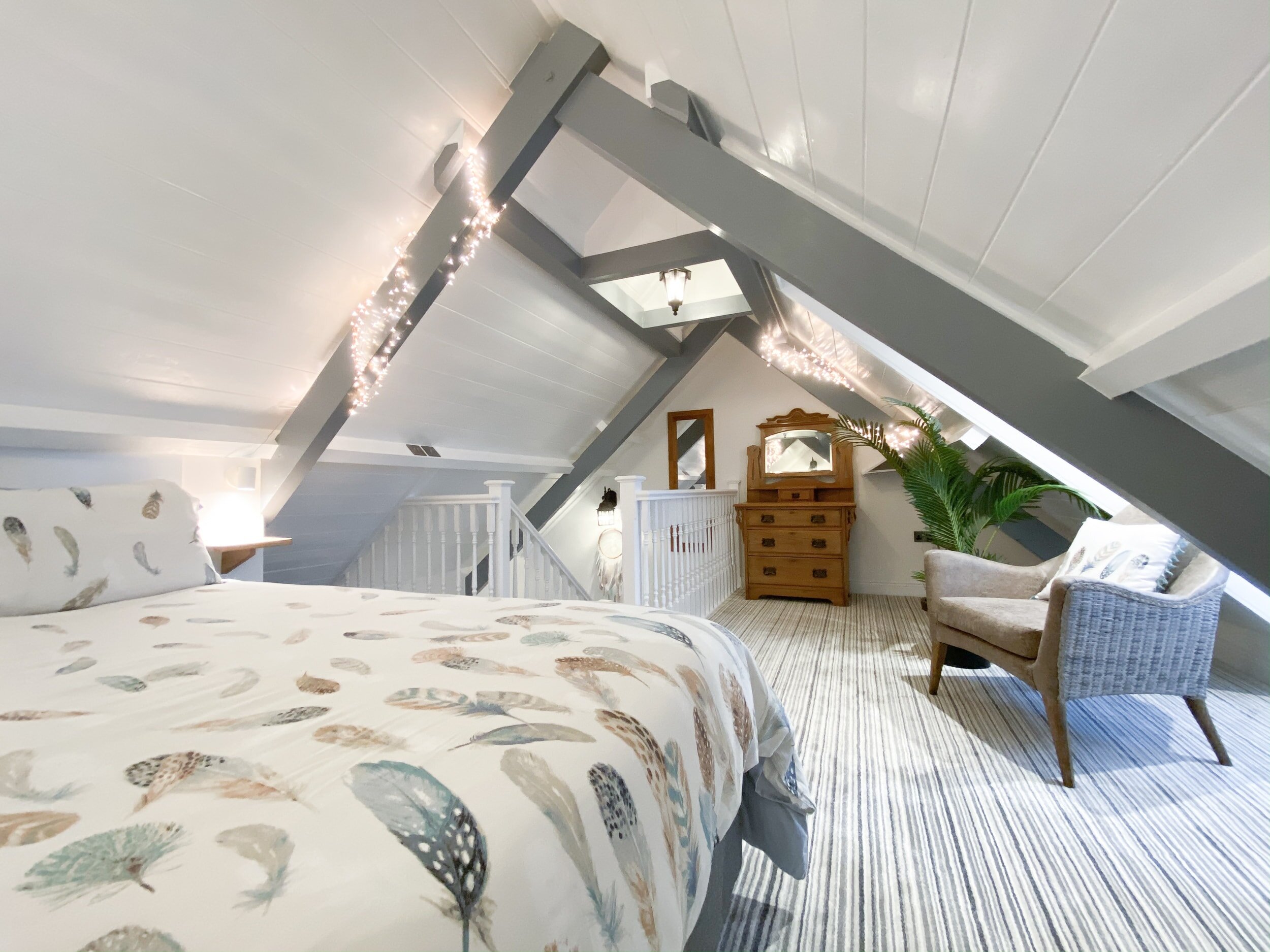 Dreamcatcher bedroom with fairy lights and sloped ceilings