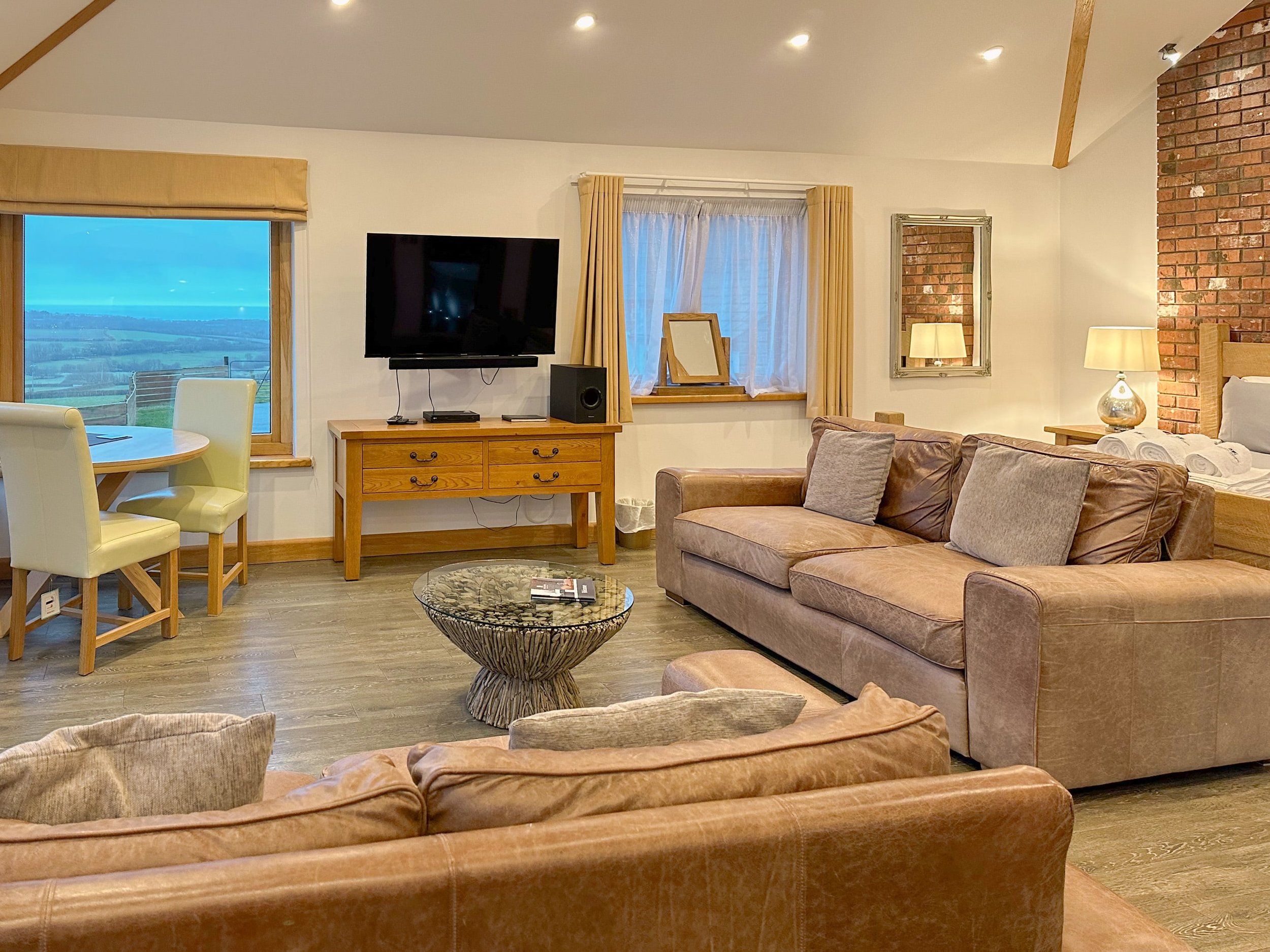 Open plan living with super-king size bed and chunky oak beams