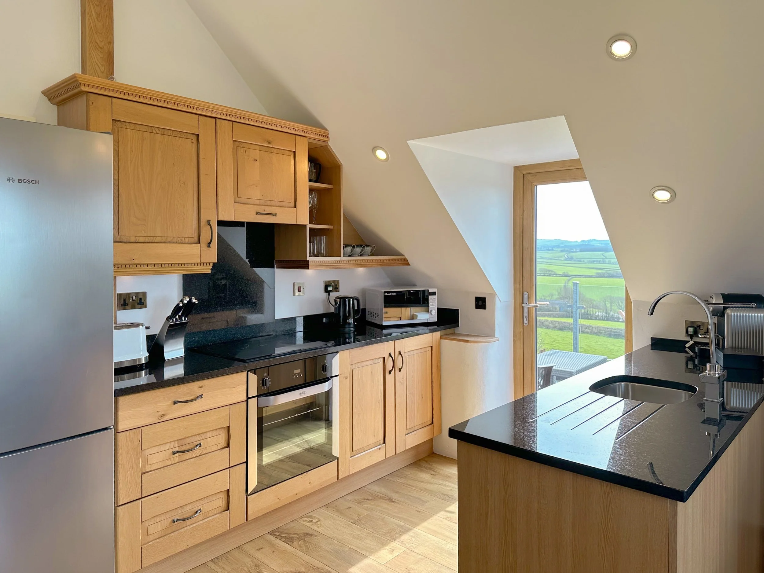 Traditional oak kitchen with black granite worktops