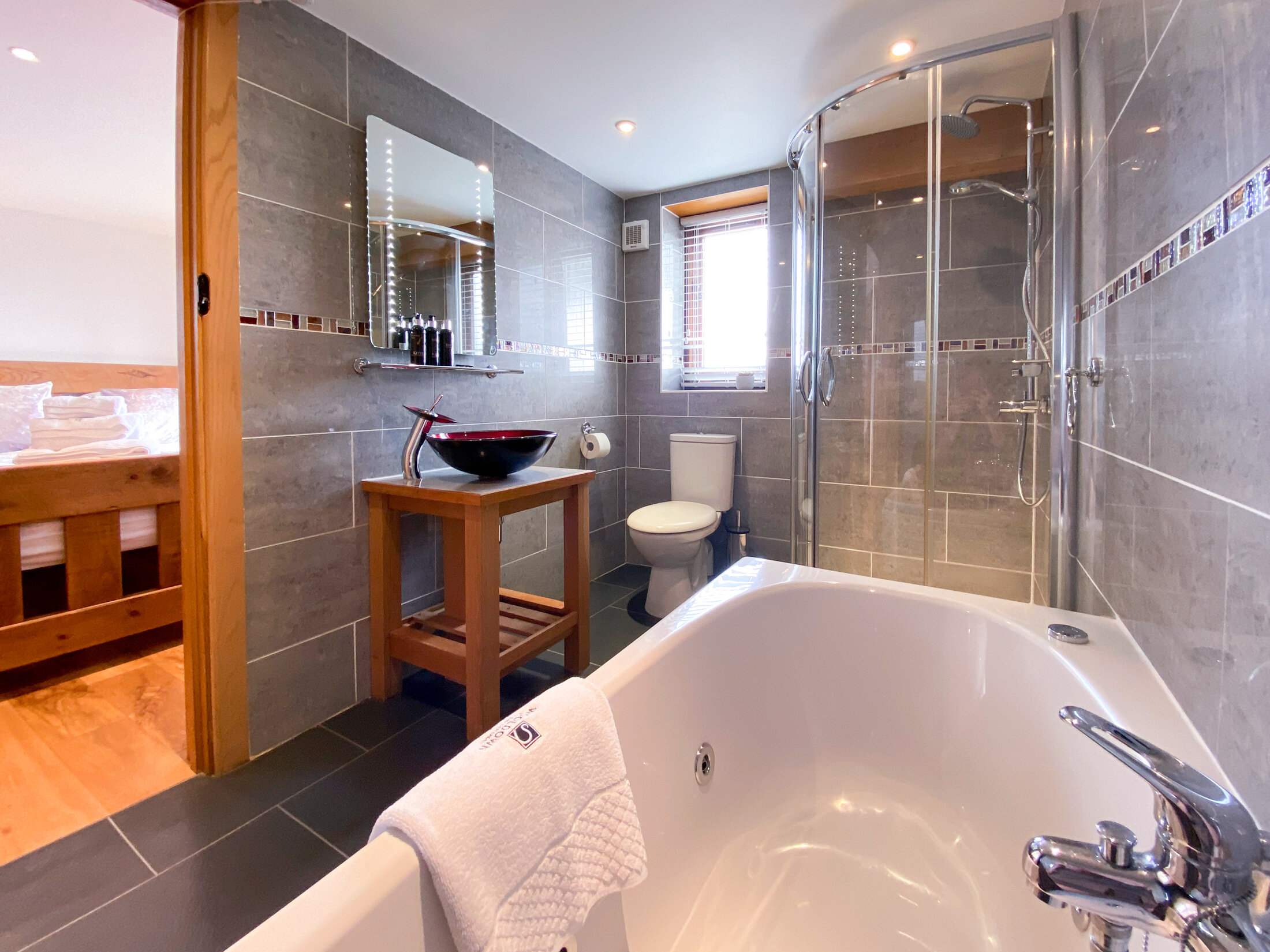 Spa bath and walk in shower in Pengenna Parlour accommodation