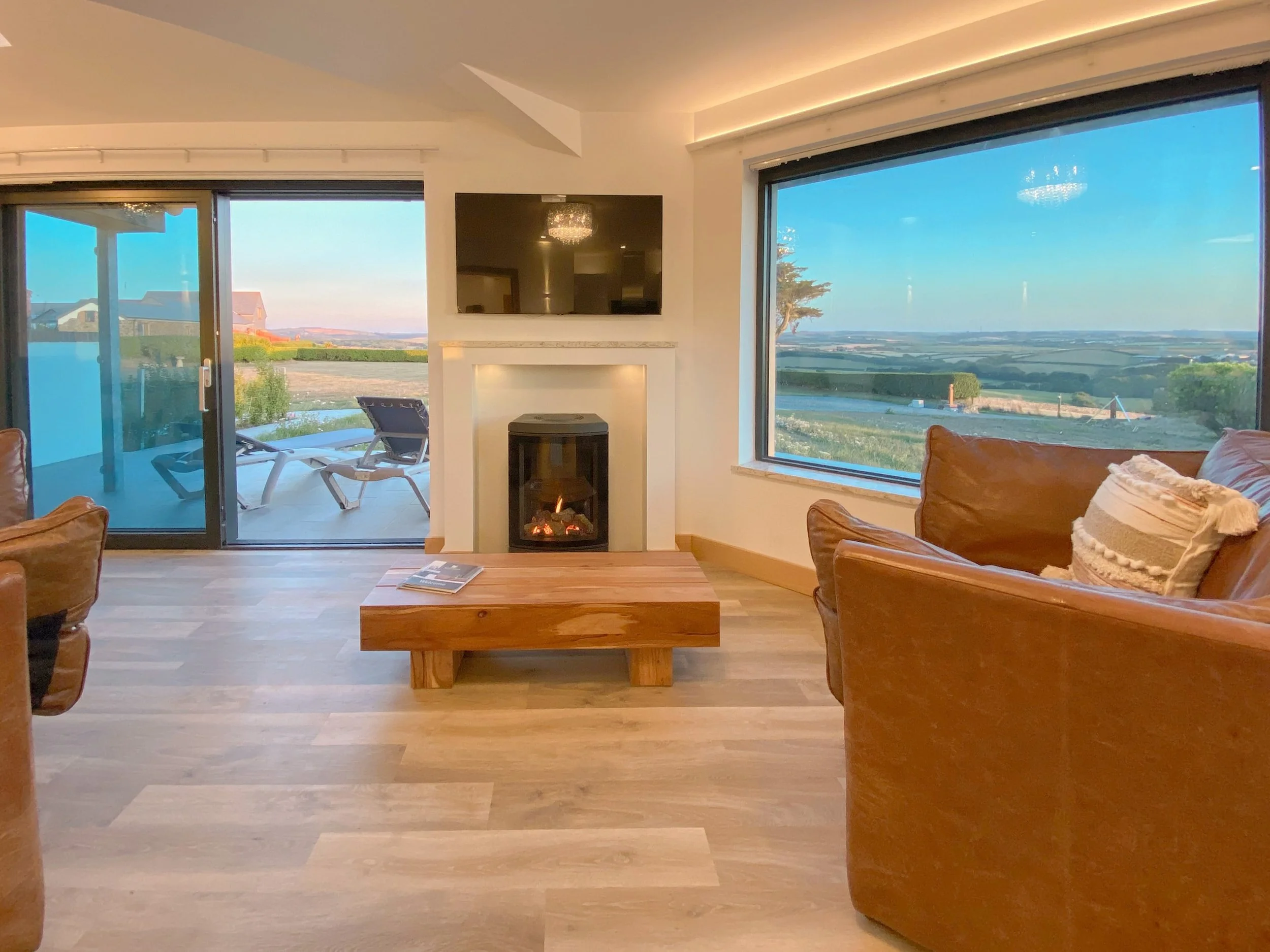 Fireplace in the accommodation at Wooldown Holiday Cottages