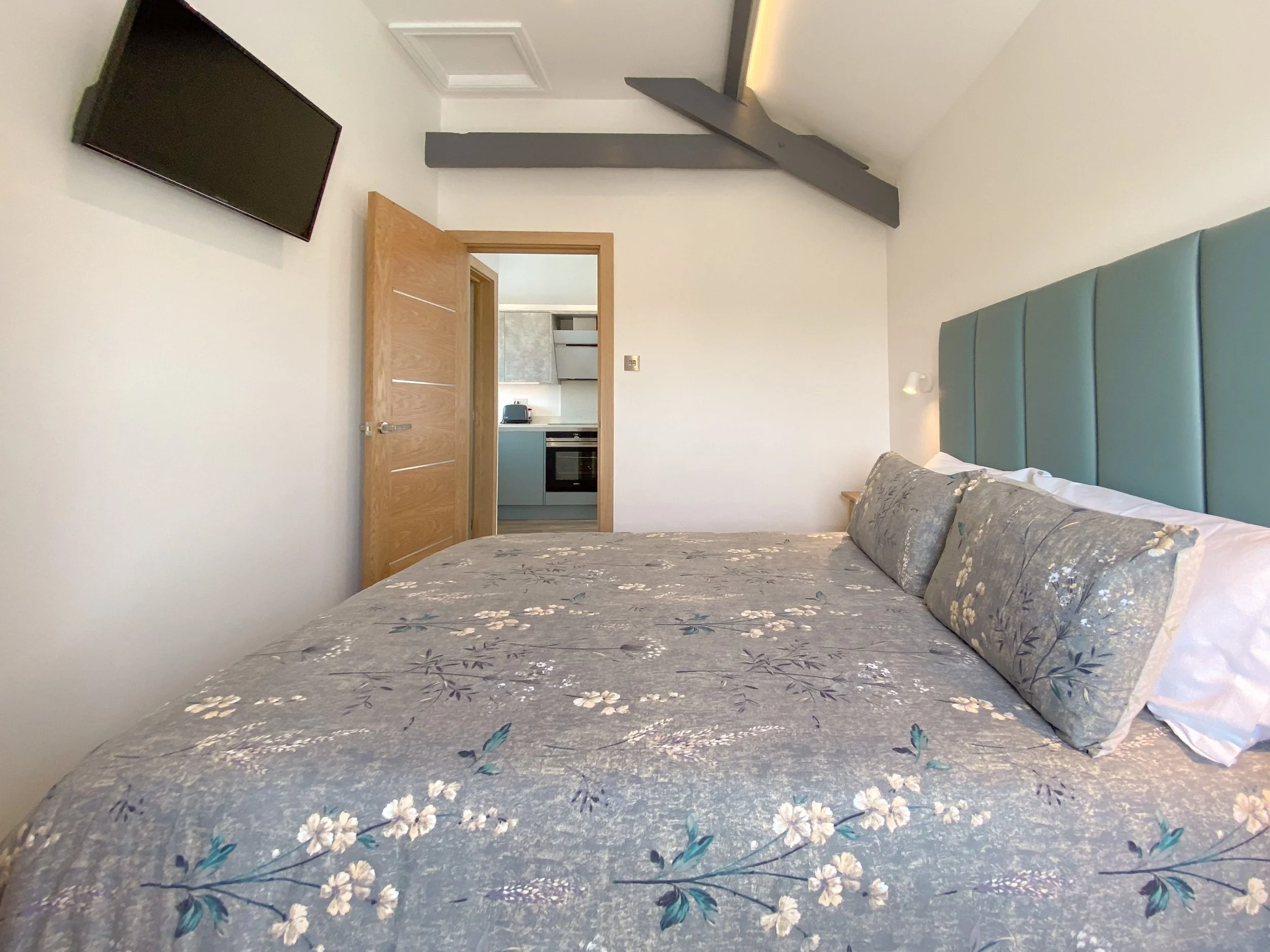 Cosy king-size bedroom with TV