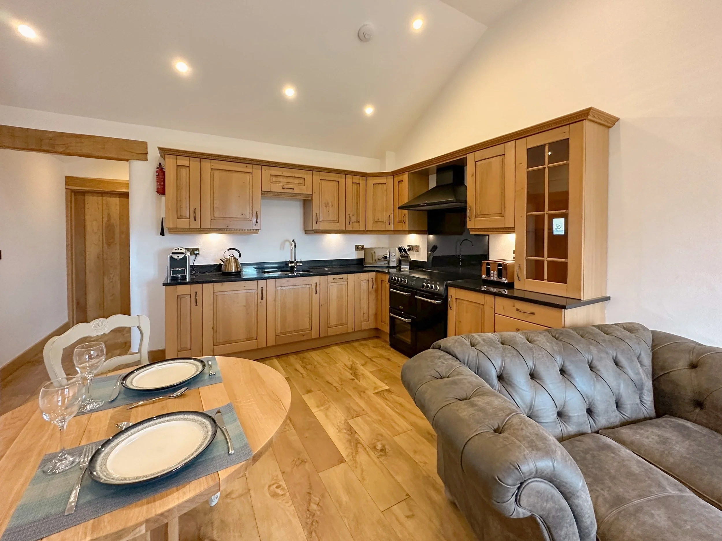 Dining area for two and fully equipped kitchen and leather sofa