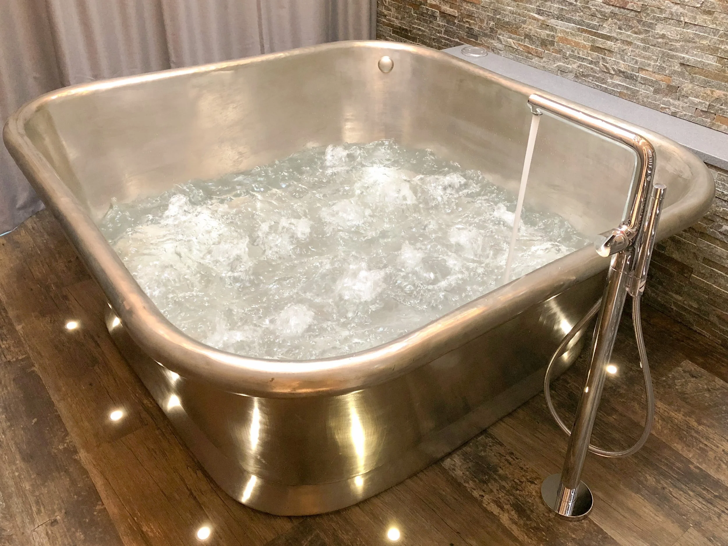 Bubbling air-spa bath with floor lighting