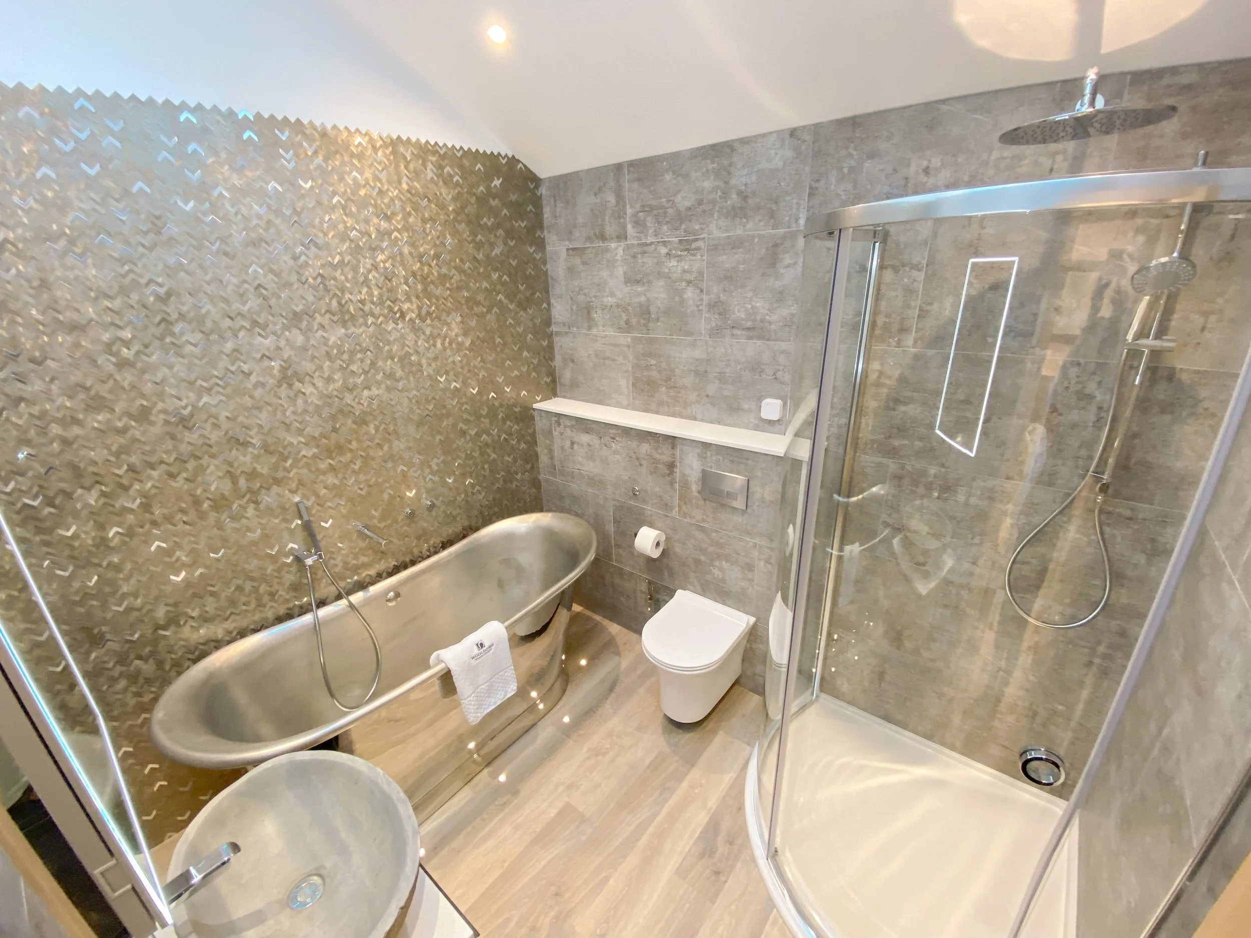 Nickel and brushed nickel freestanding bath with Sensori controls