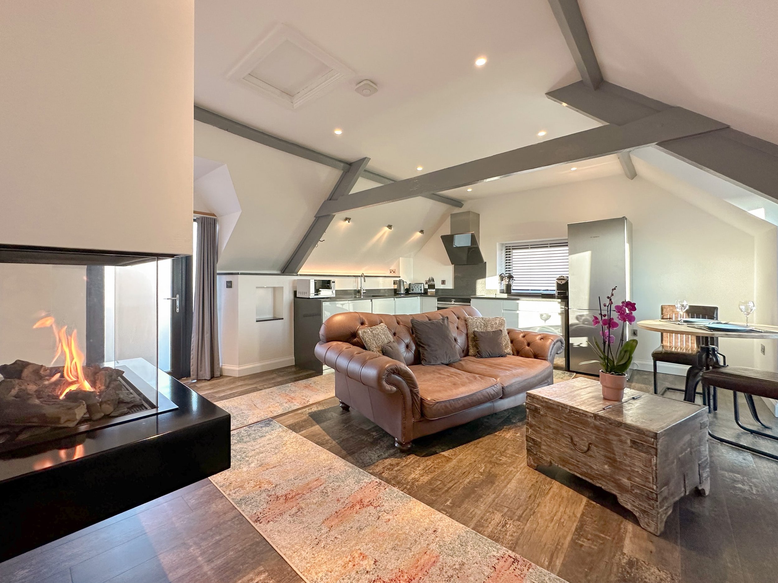 Skyfall living area with large flame fire