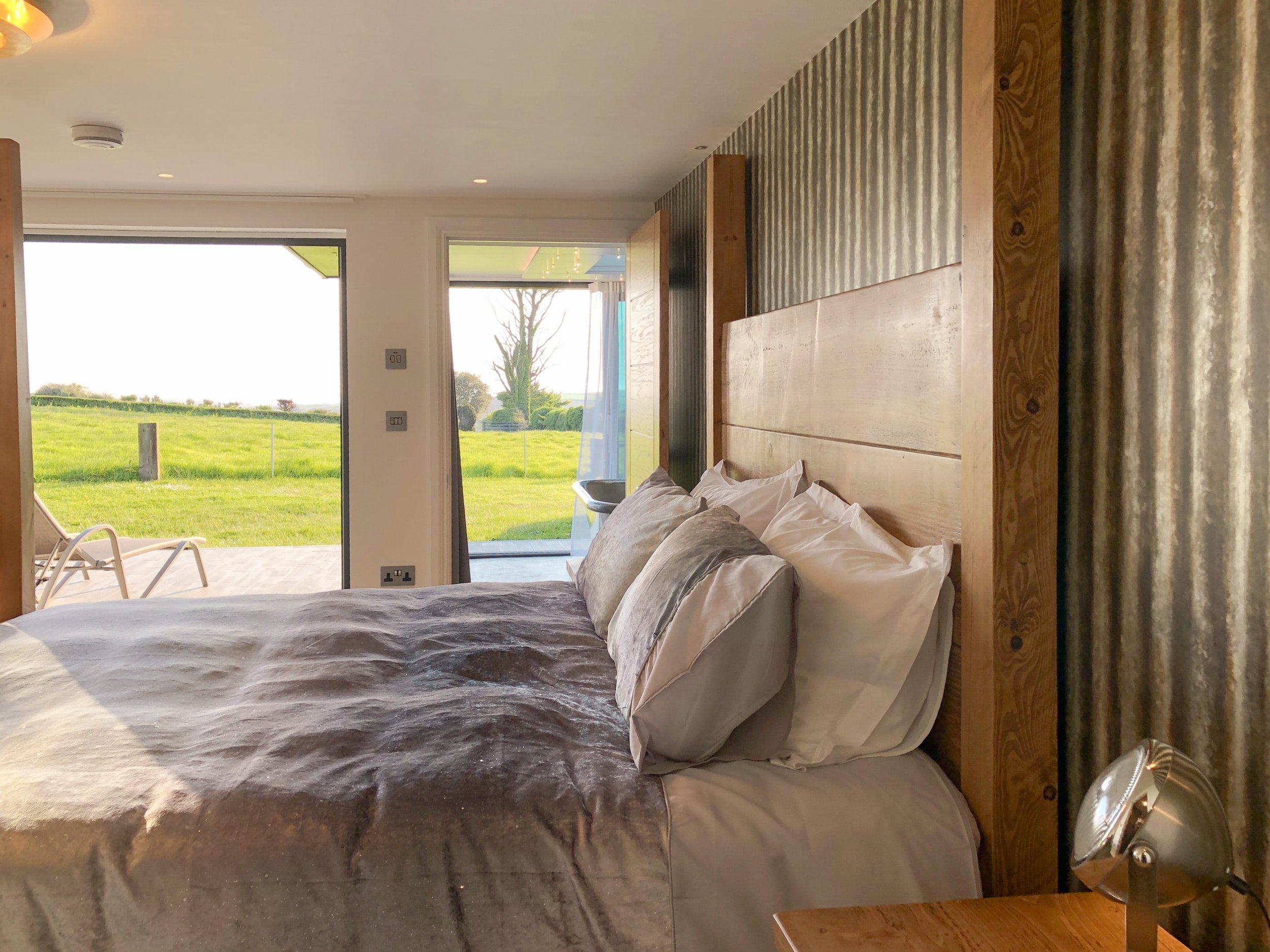 Four poster plank bed in Sun Seeker with countryside and sea view