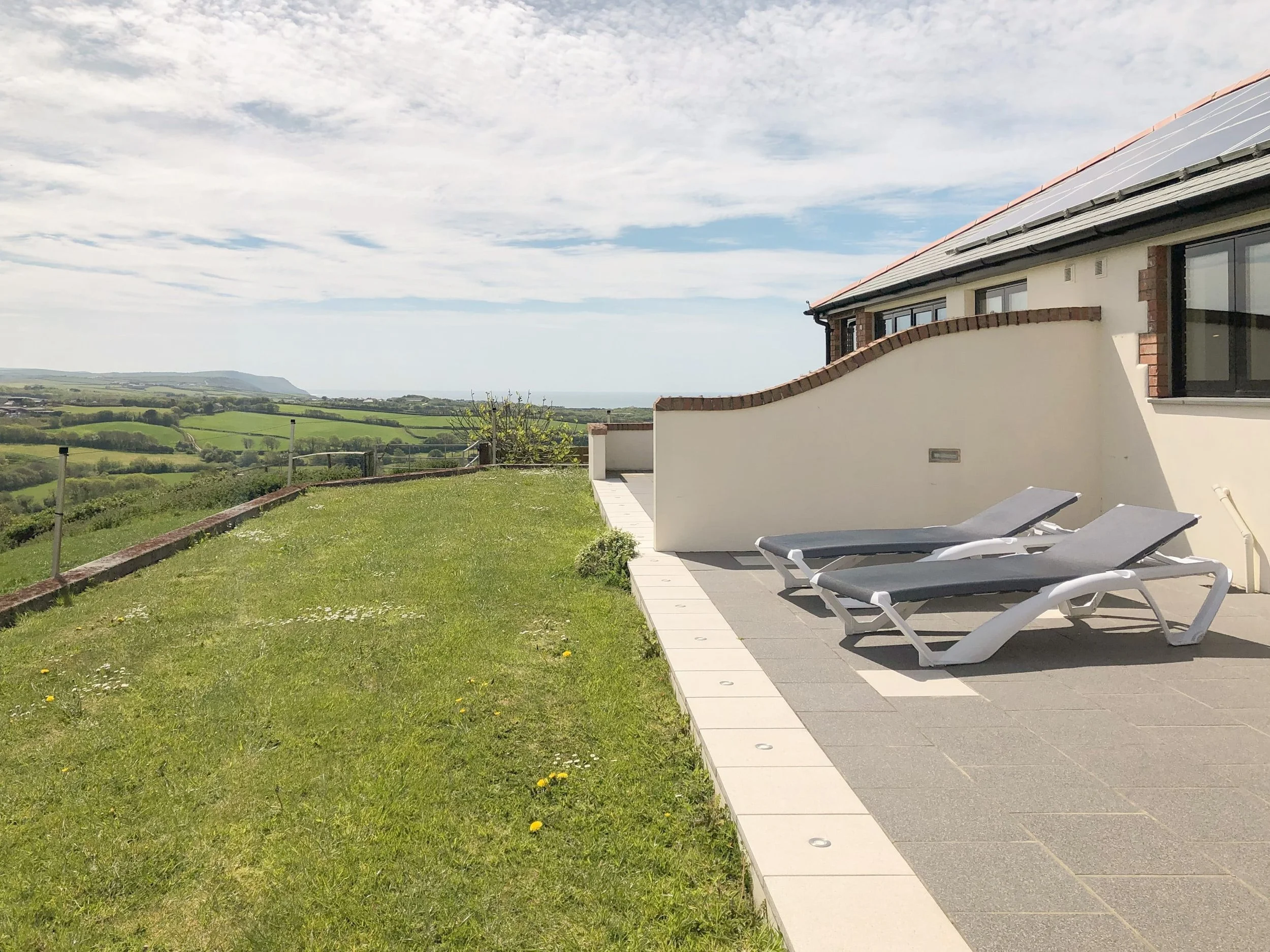 Patio area with sun loungers and valley views
