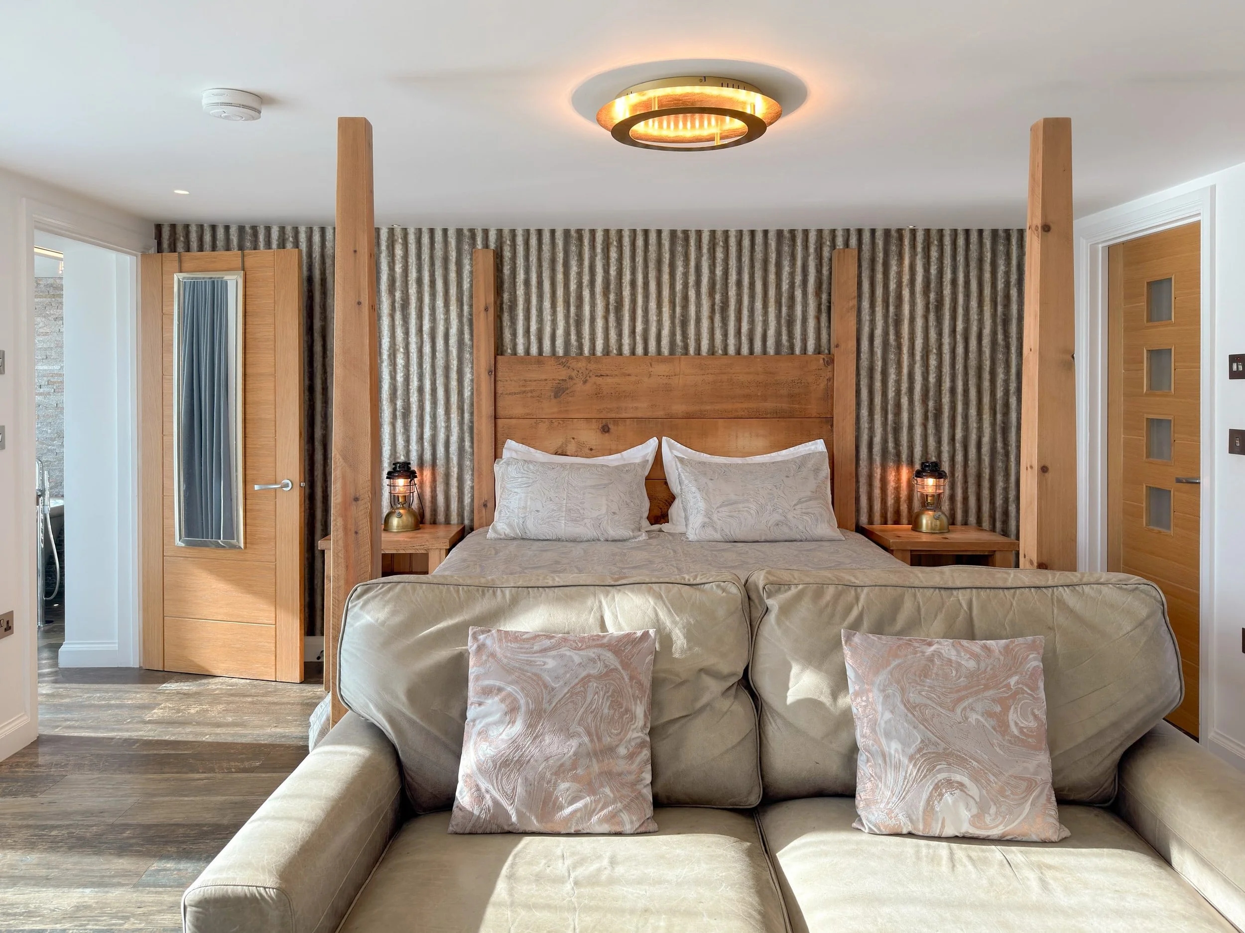 Open plan bedroom with four poster bed