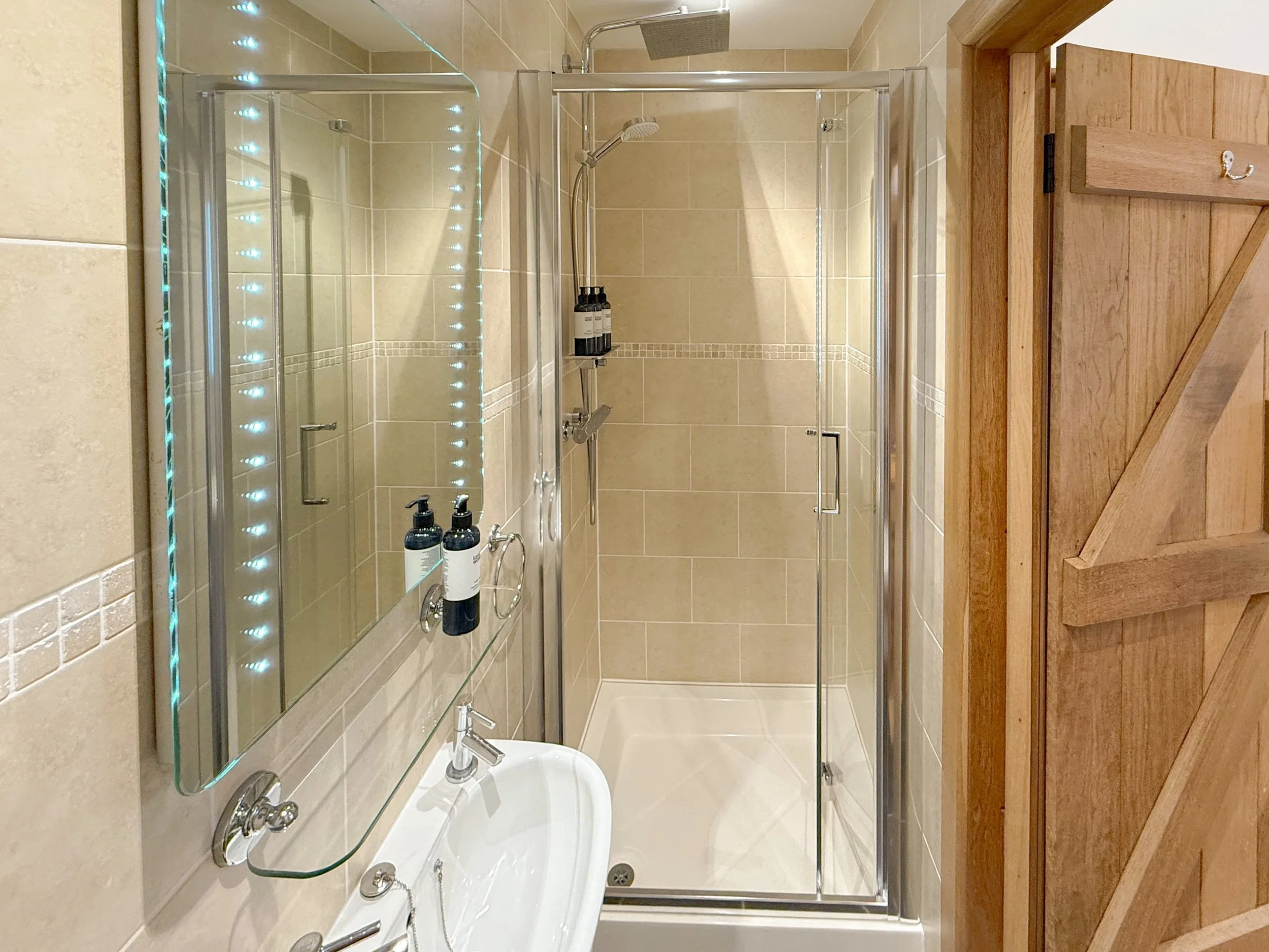 Small shower room with LED mirror