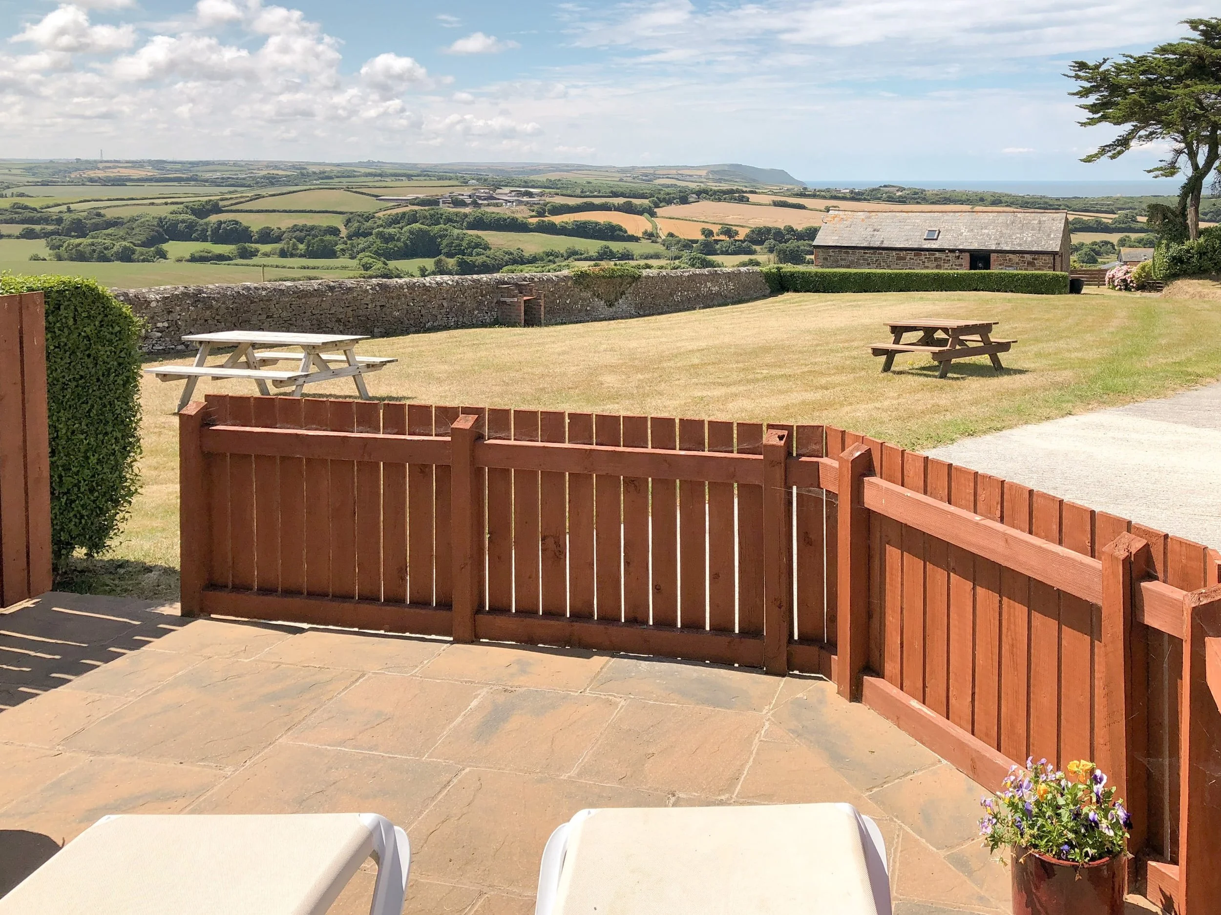 Patio area with rolling countryside and sea views