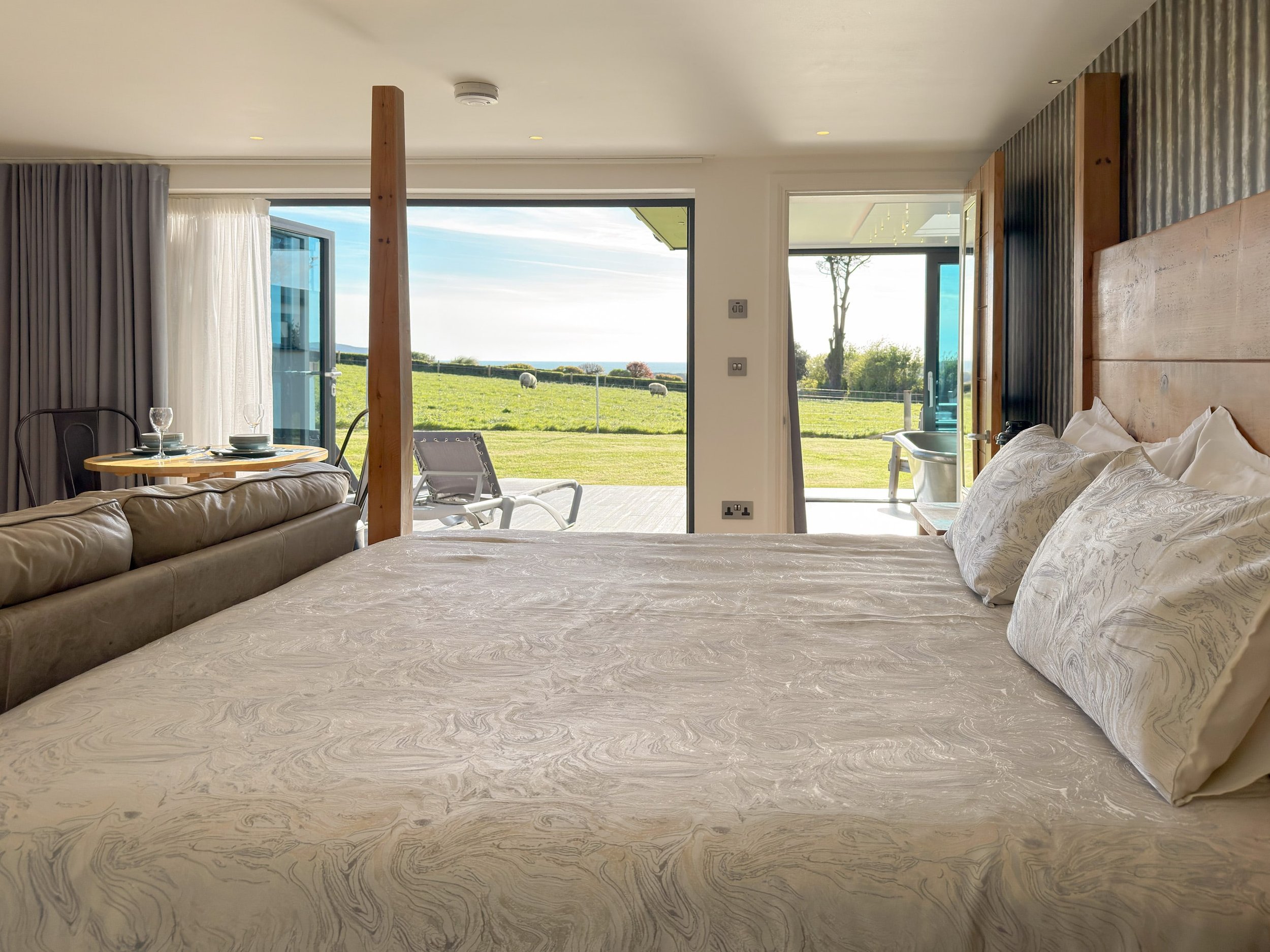 Four poster plank bed in Sun Seeker with countryside and sea view