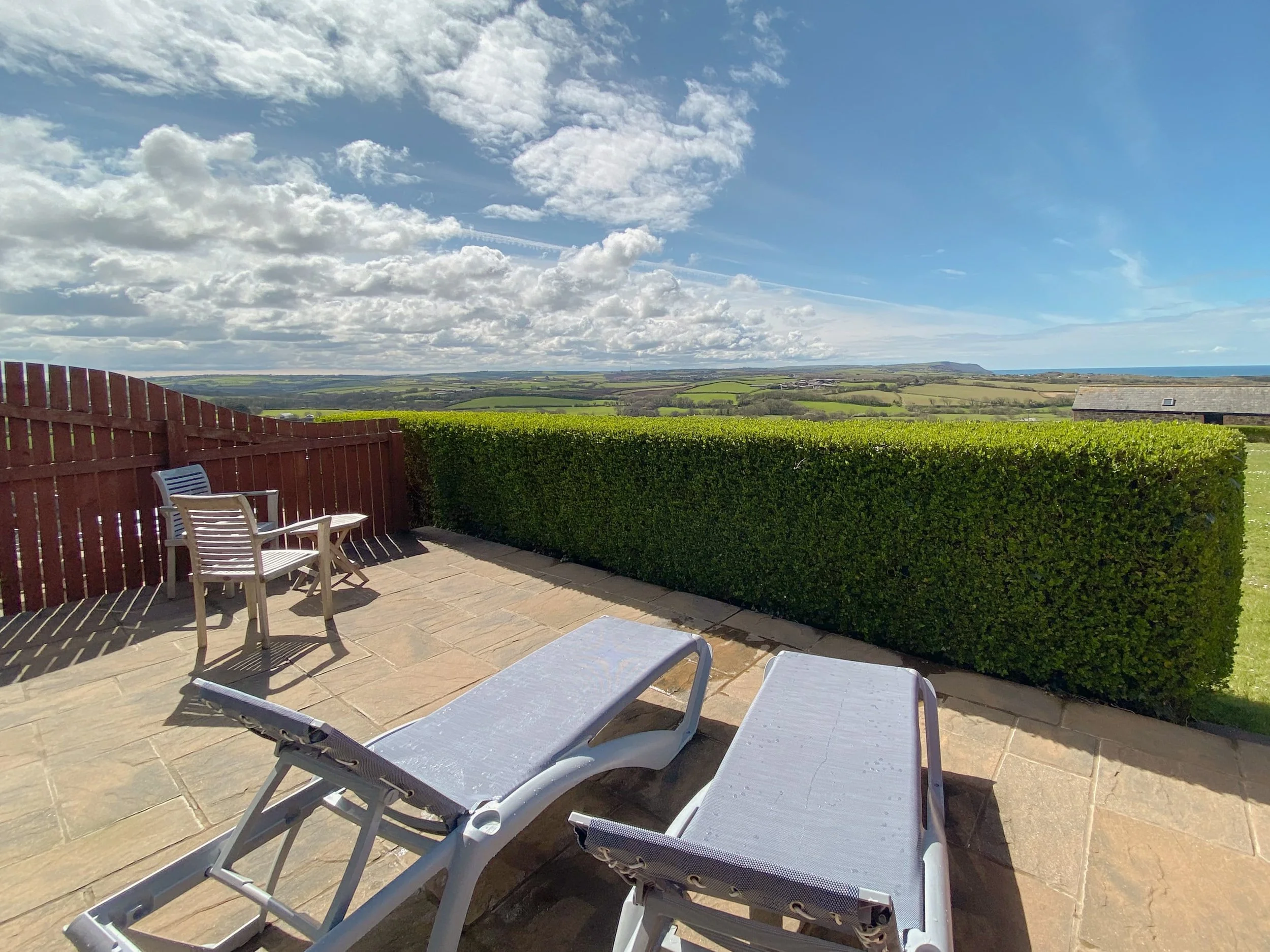 Patio area with sun loungers and sea views