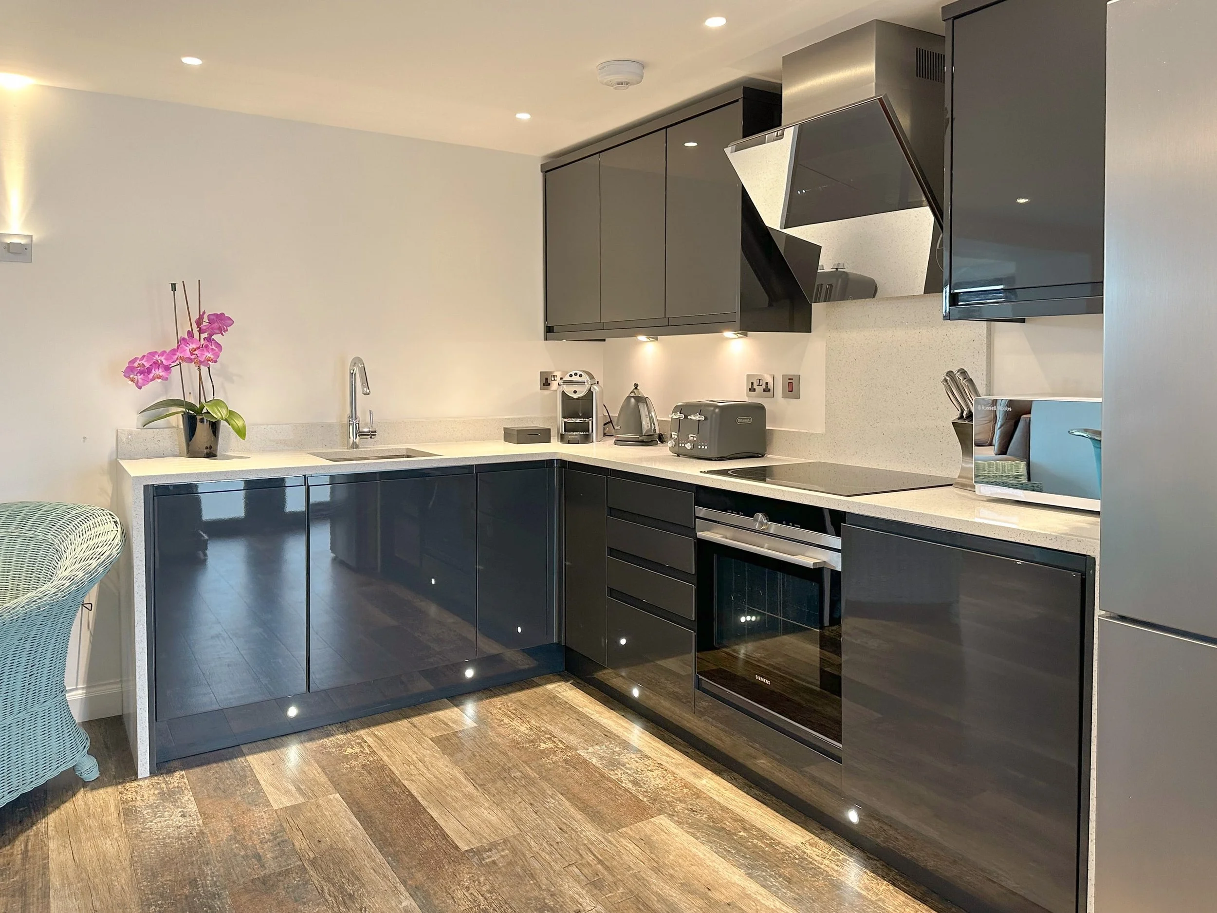 Grey gloss kitchen and white worktops