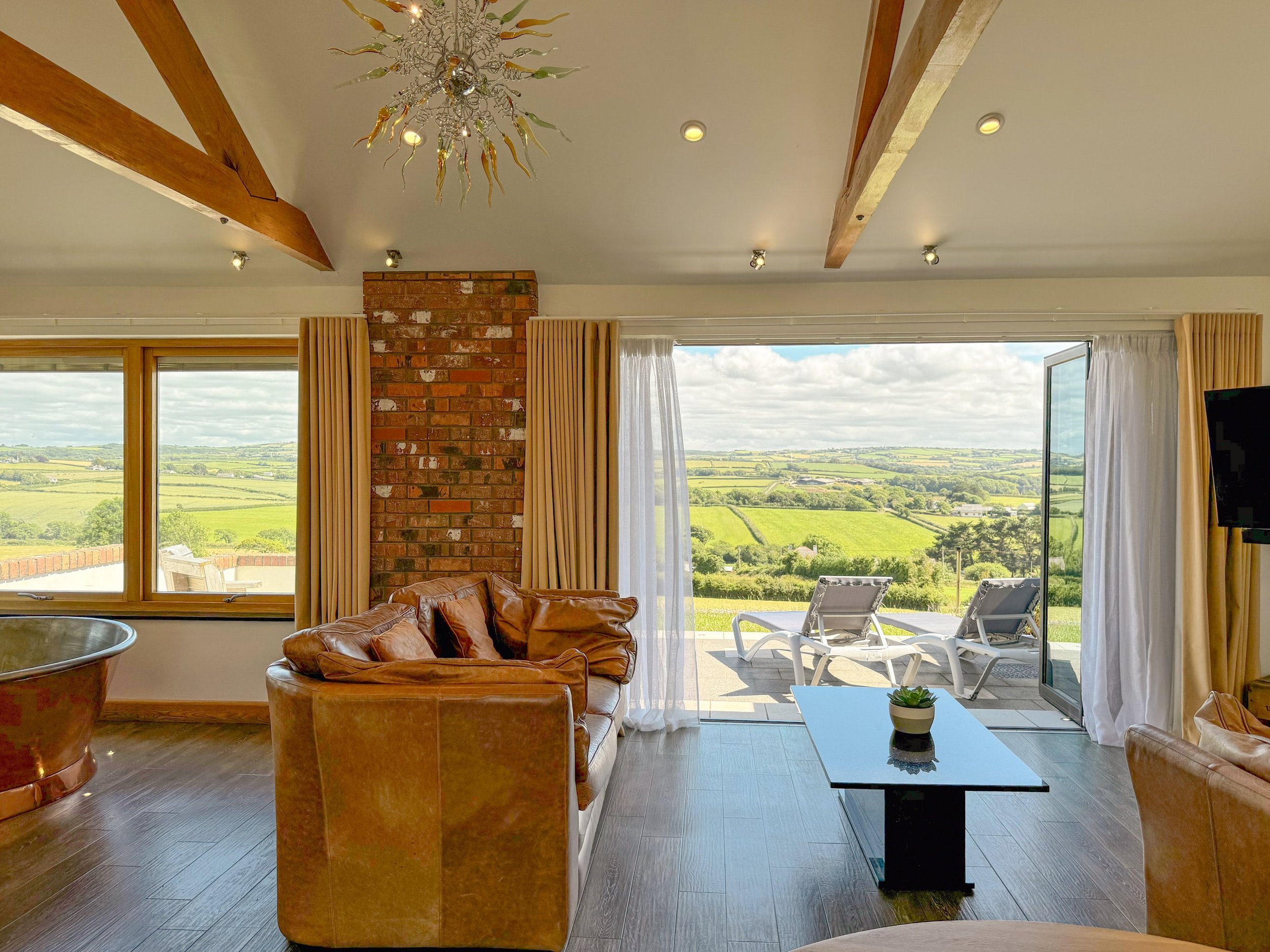 Open plan apartment with air-spa bath and bi-folding doors with countryside view
