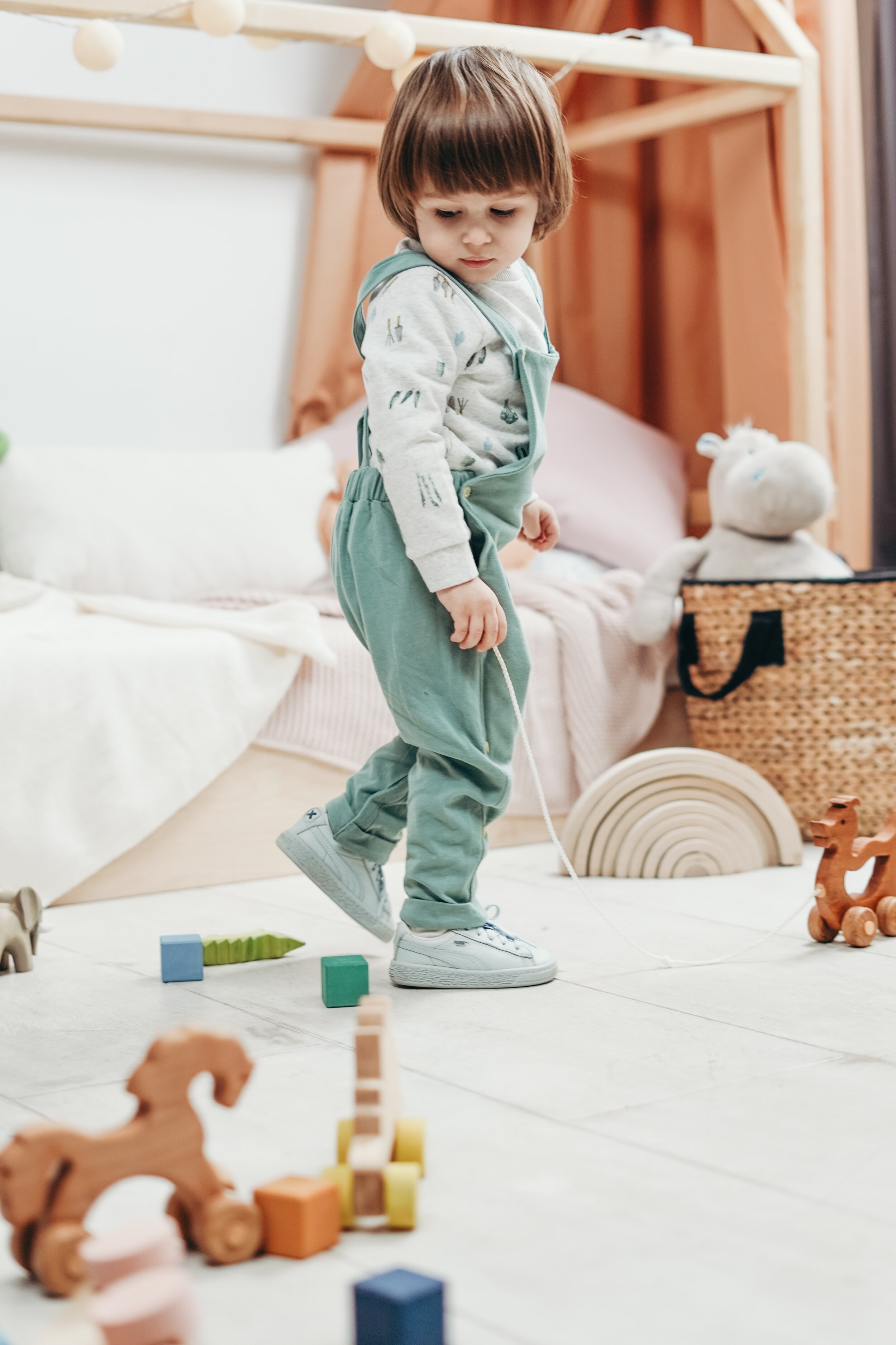 child-in-white-long-sleeve-top-and-green-dungaree-trousers-3661369.jpg