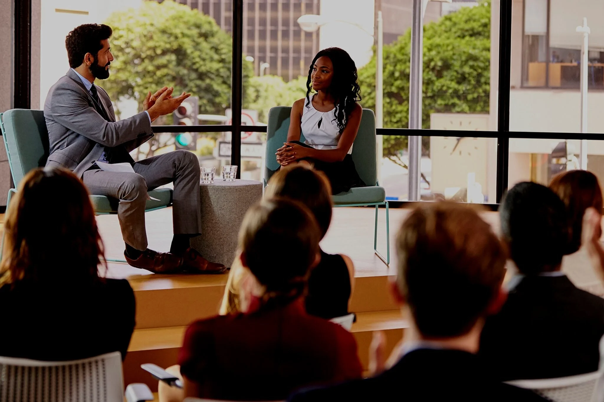 man-and-woman-talk-in-front-of-audience-at-PKXD2WG.jpg