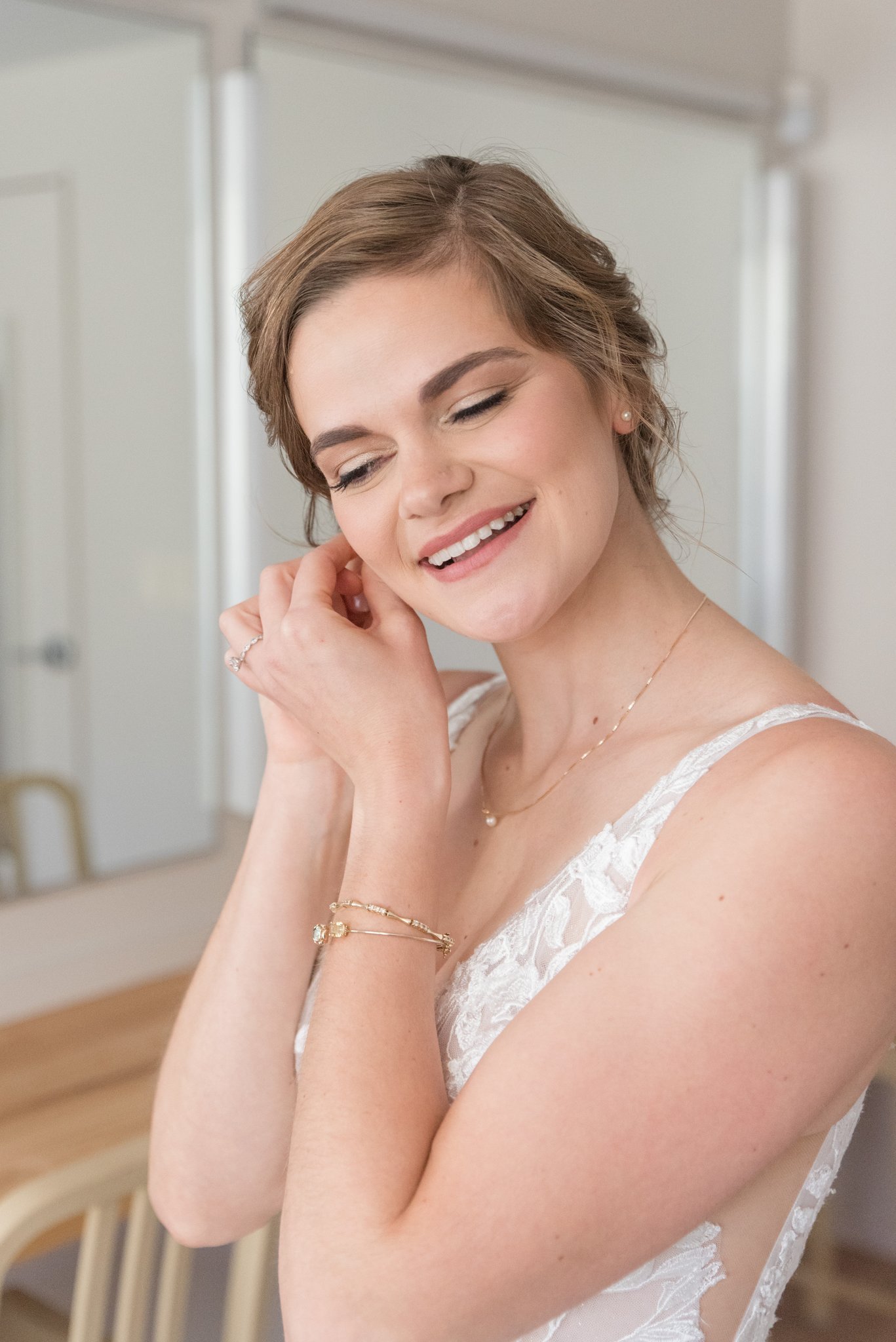 Bride putting on earrings| updo| bridal makeup| bridal pictures | Heather Marie Leicy.jpg