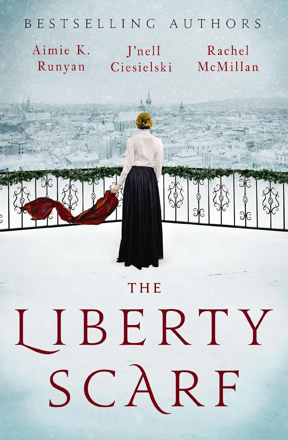 Book cover of 'The Liberty Scarf' showing a woman with blonde hair in a white blouse and long black skirt, holding a red scarf, standing on a snowy balcony overlooking a cityscape with a misty sky and text listing the authors.