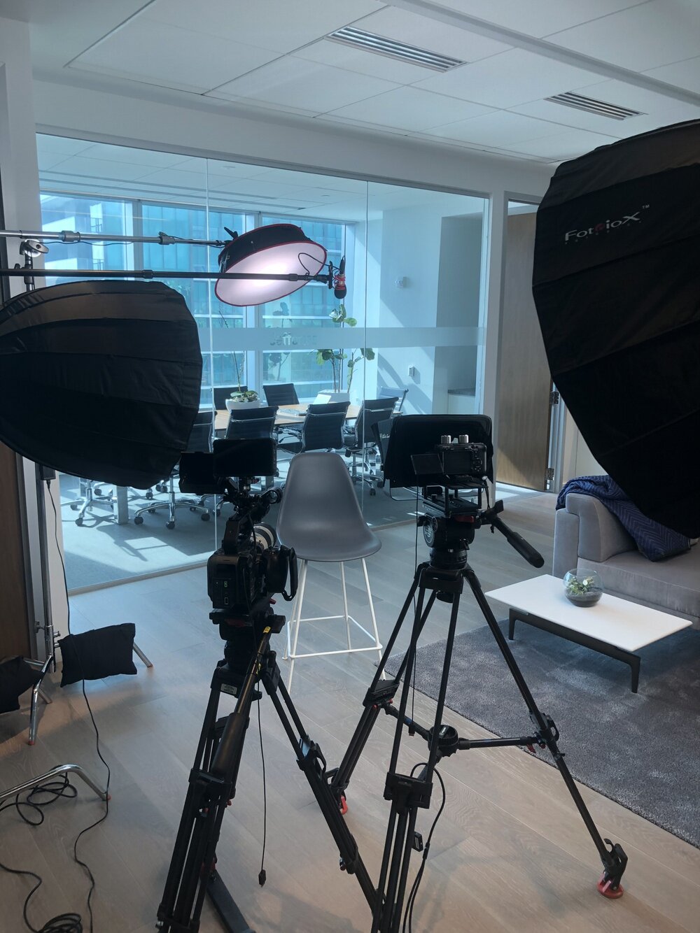 In this behind-the-scenes shot, you can see an overhead mic placed just above the chair and close to where the talent will sit.&nbsp;