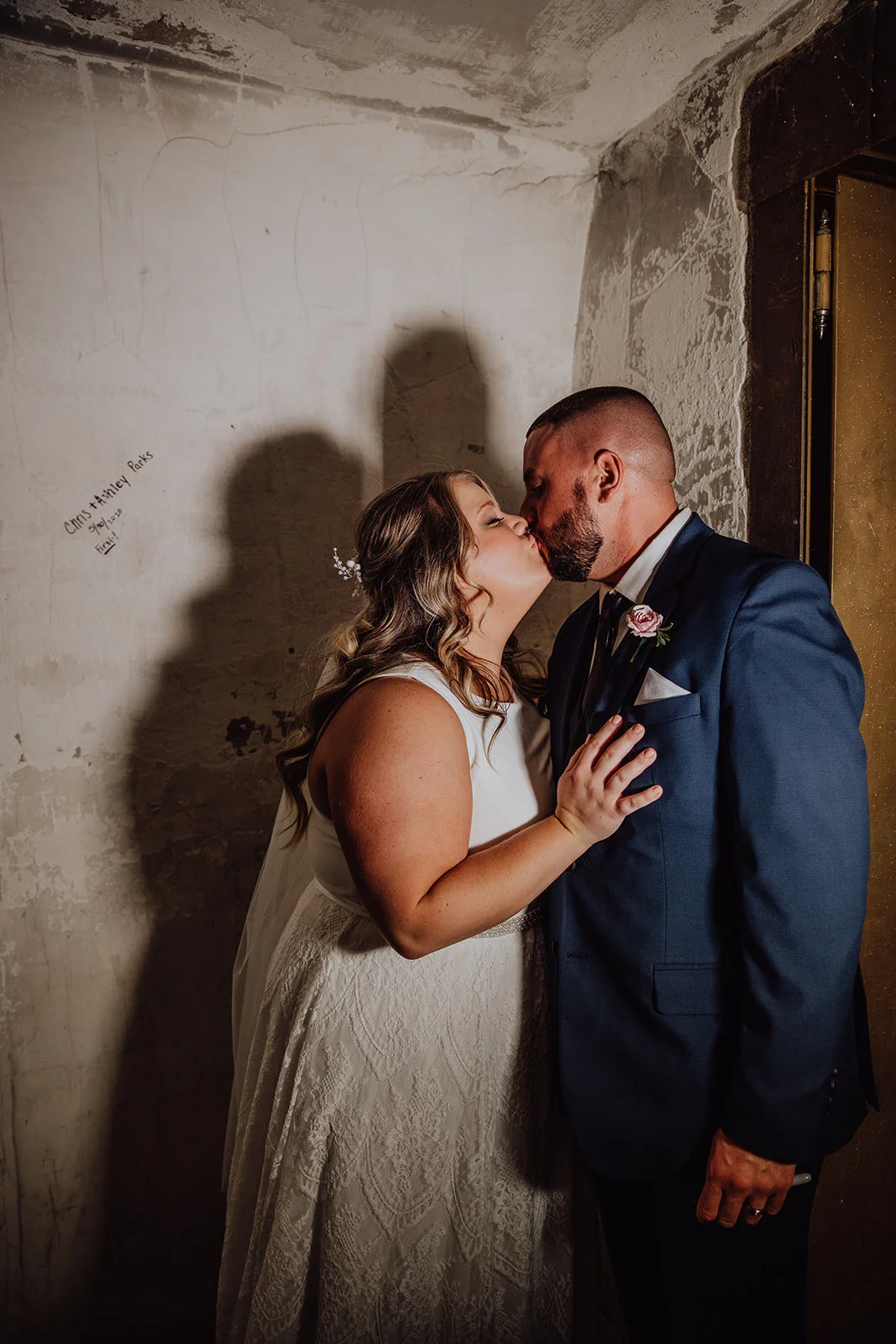 Couple inside vault next to their name after signing the wall