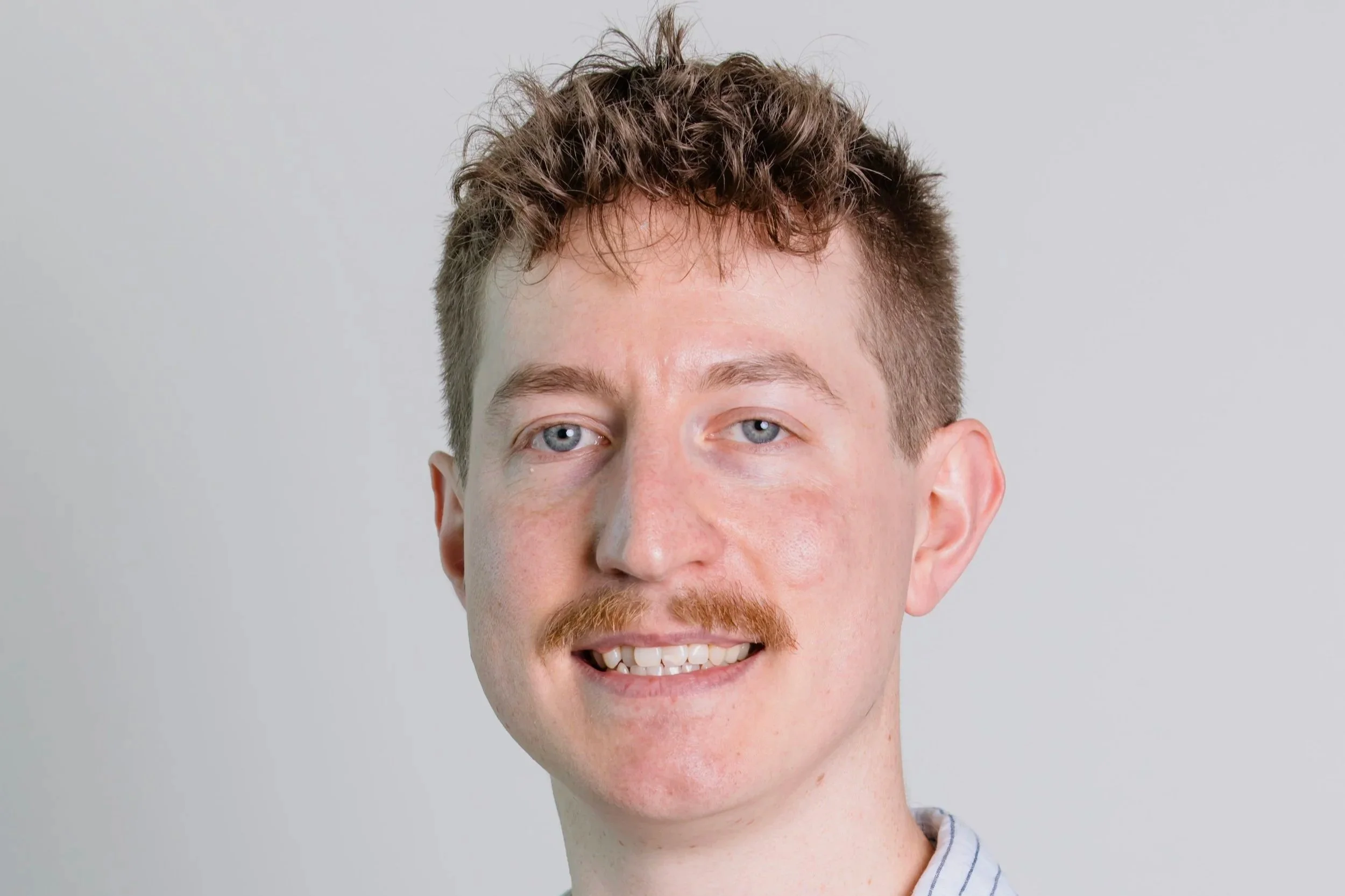 Head shot of Callum Dark with short brown hair.