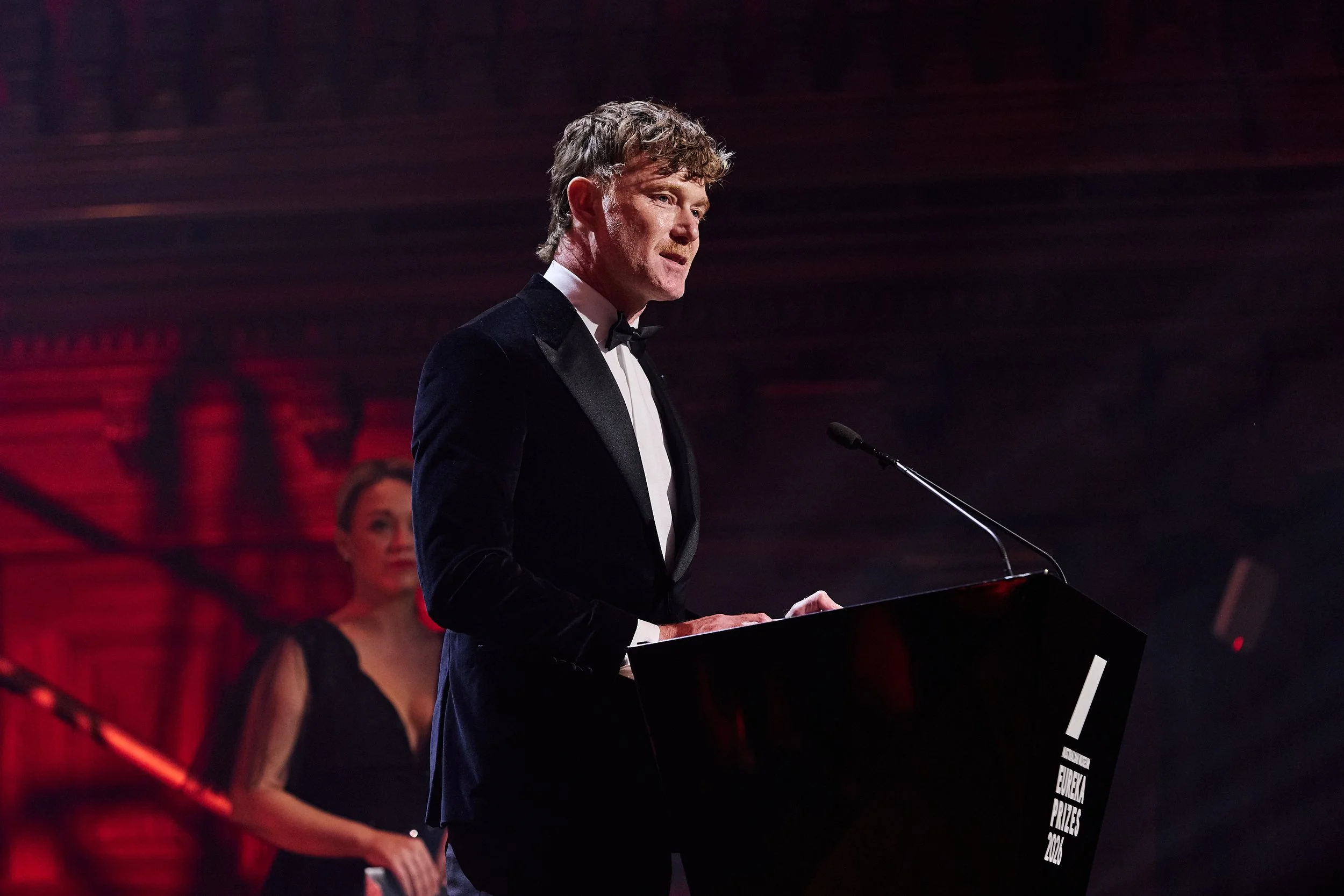 Dr Ryan Jefferies delivering a speech on stage.