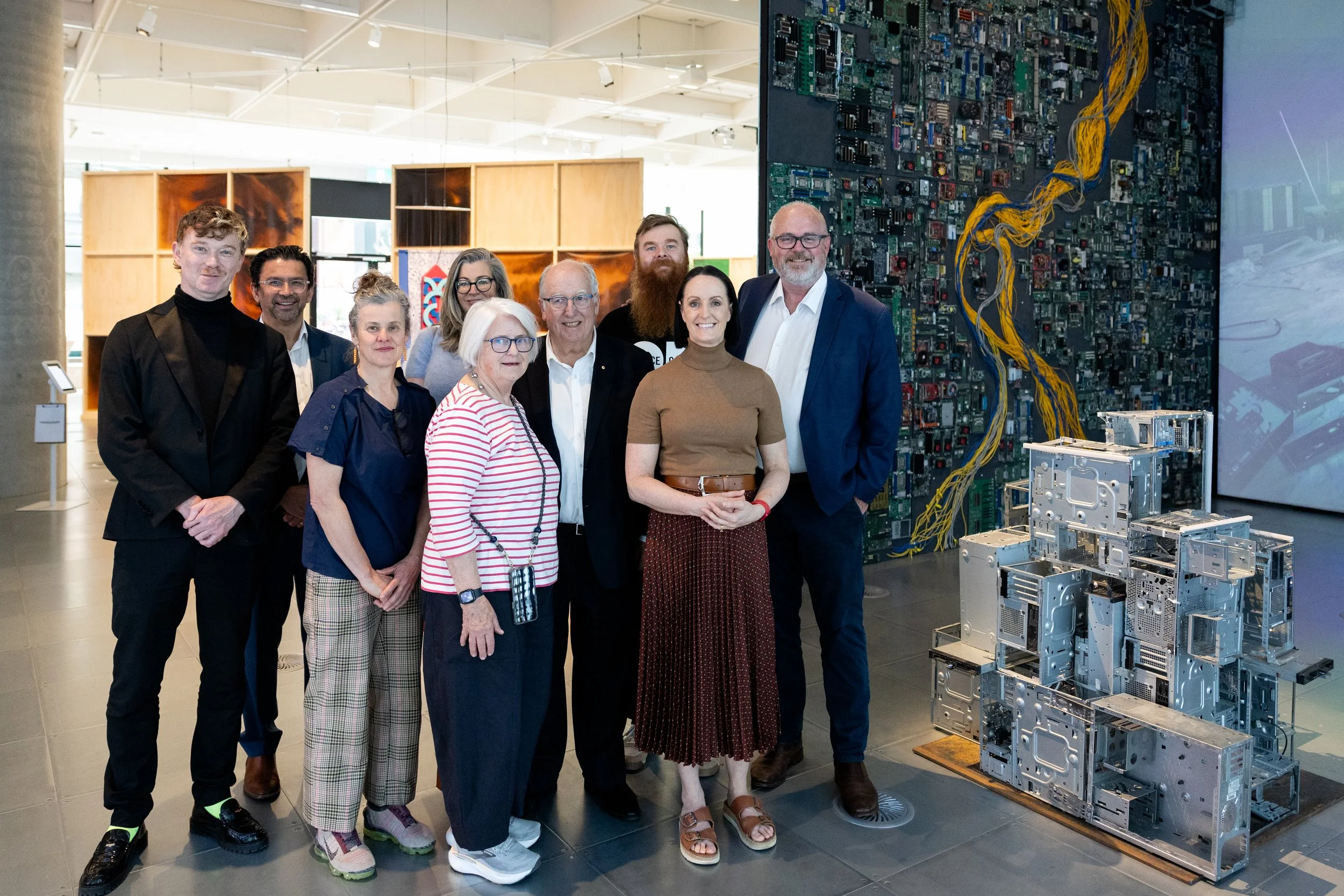 A group of people stand in the Science Gallery Melbourne at the Deaf Art Science Festival.