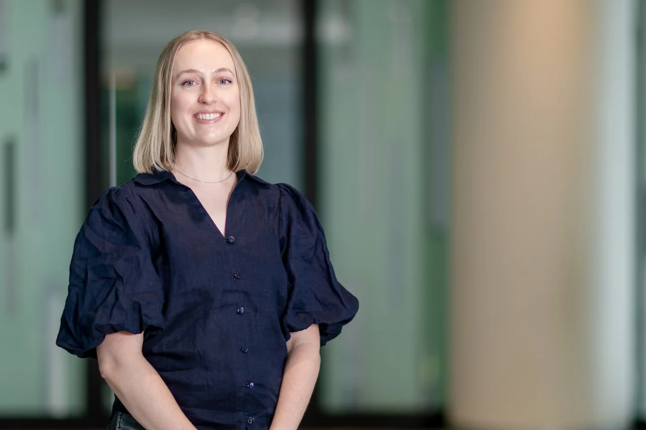 Head shot of Dr Rhiannon Werder with short blond hair, wearing a black top.