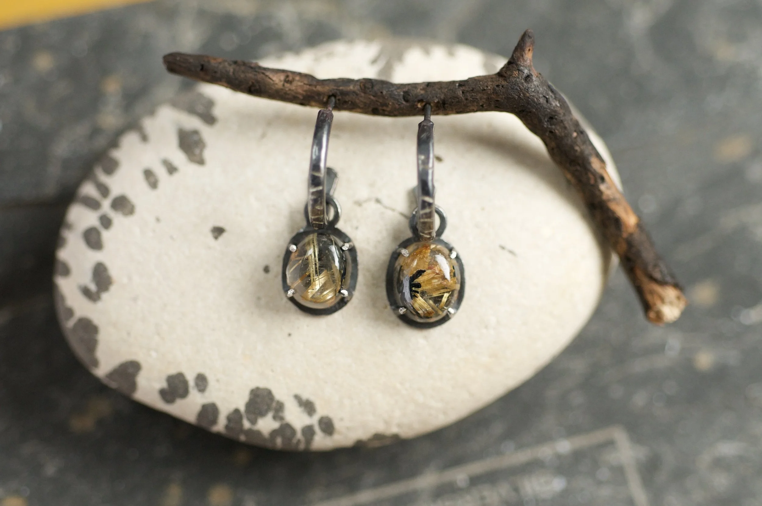 Black and gold hoop earrings with rutile quartz