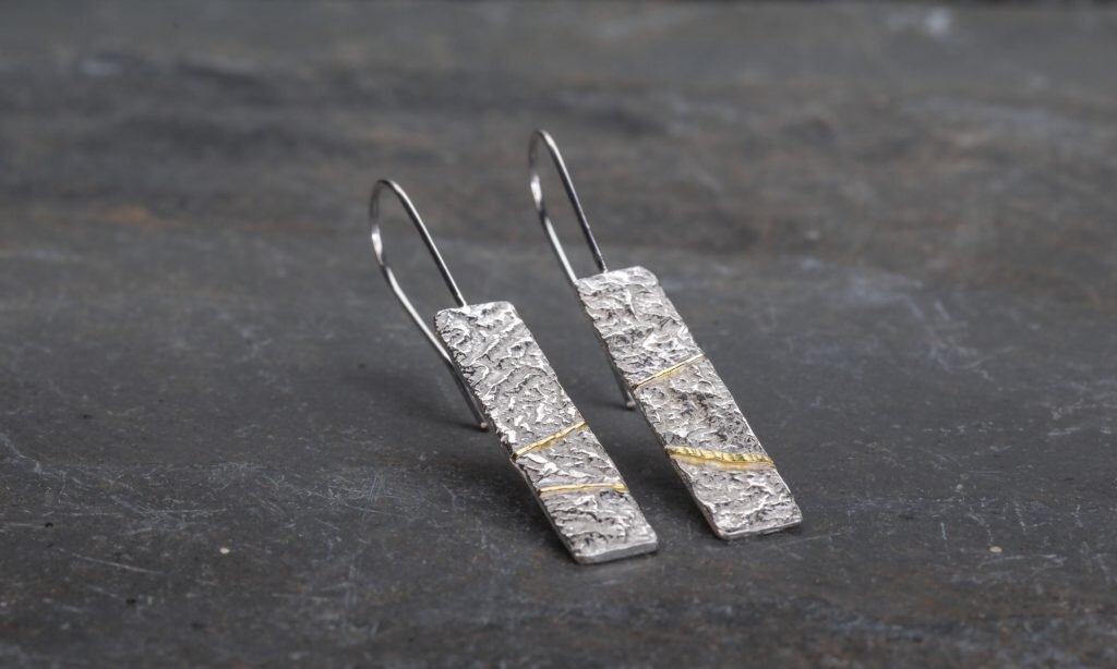 textured silver earrings with gold seams