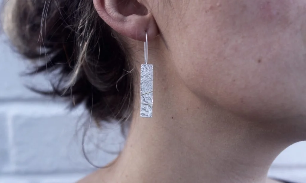 textured silver earrings with gold stripe