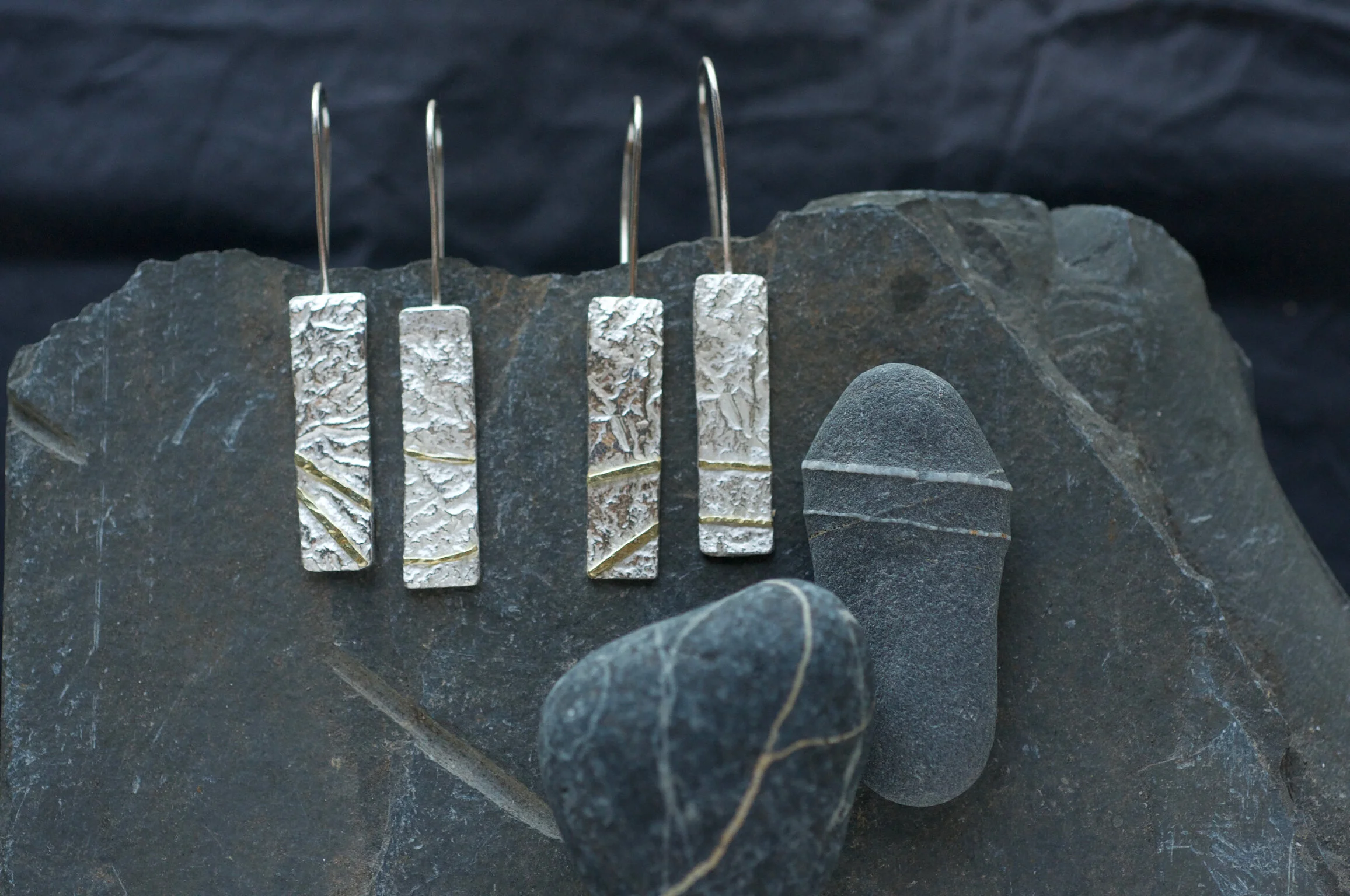 textured silver earrings with gold seams