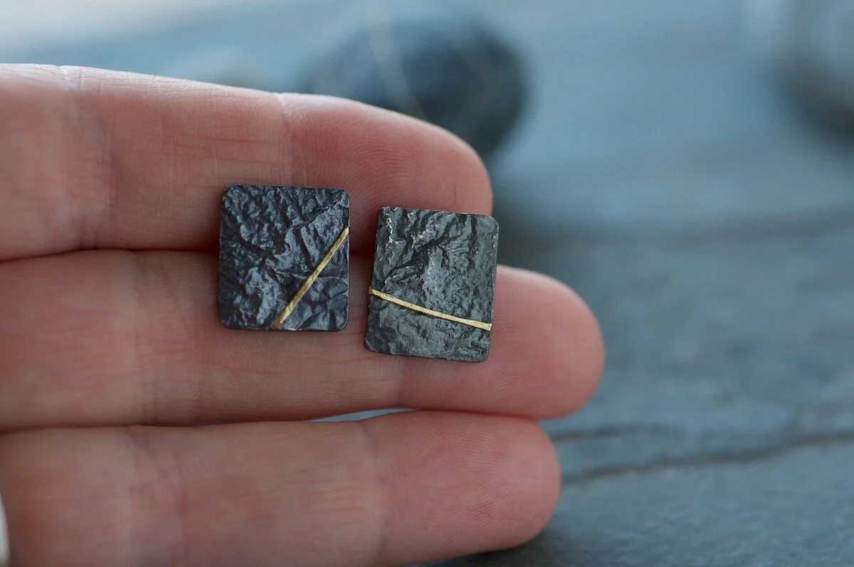 Oxidised silver and gold square studs line hand.jpg