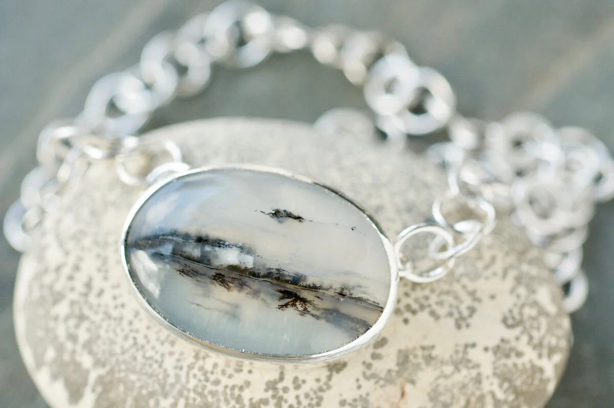 Oval dendritic quartz on silver chain light.jpg
